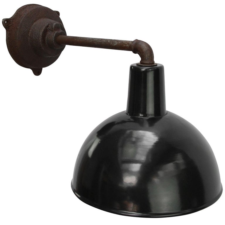 Factory wall light. Black enamel. White interior. 

Diameter cast iron wall piece: 12 cm, three holes to secure.

Weight: 3.00 kg / 6.6 lb

Priced per individual item. All lamps have been made suitable by international standards for