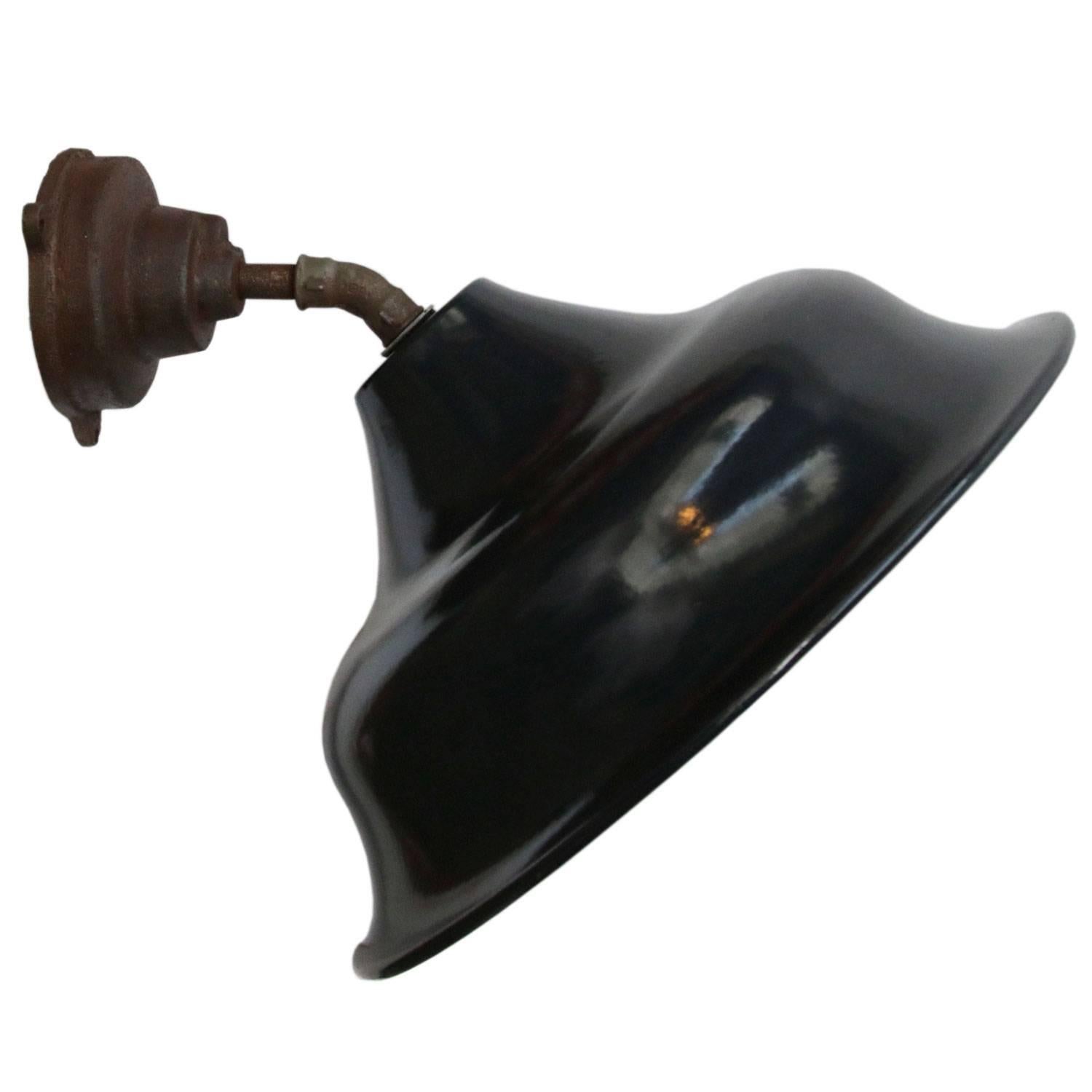 Factory wall light
45 degrees
Dark blue / black enamel, white interior

diameter cast iron wall piece: 12 cm, 3 holes to secure

E26 / E27

Weight: 3.9 kg / 8.6 lb

Priced per individual item. All lamps have been made suitable by international