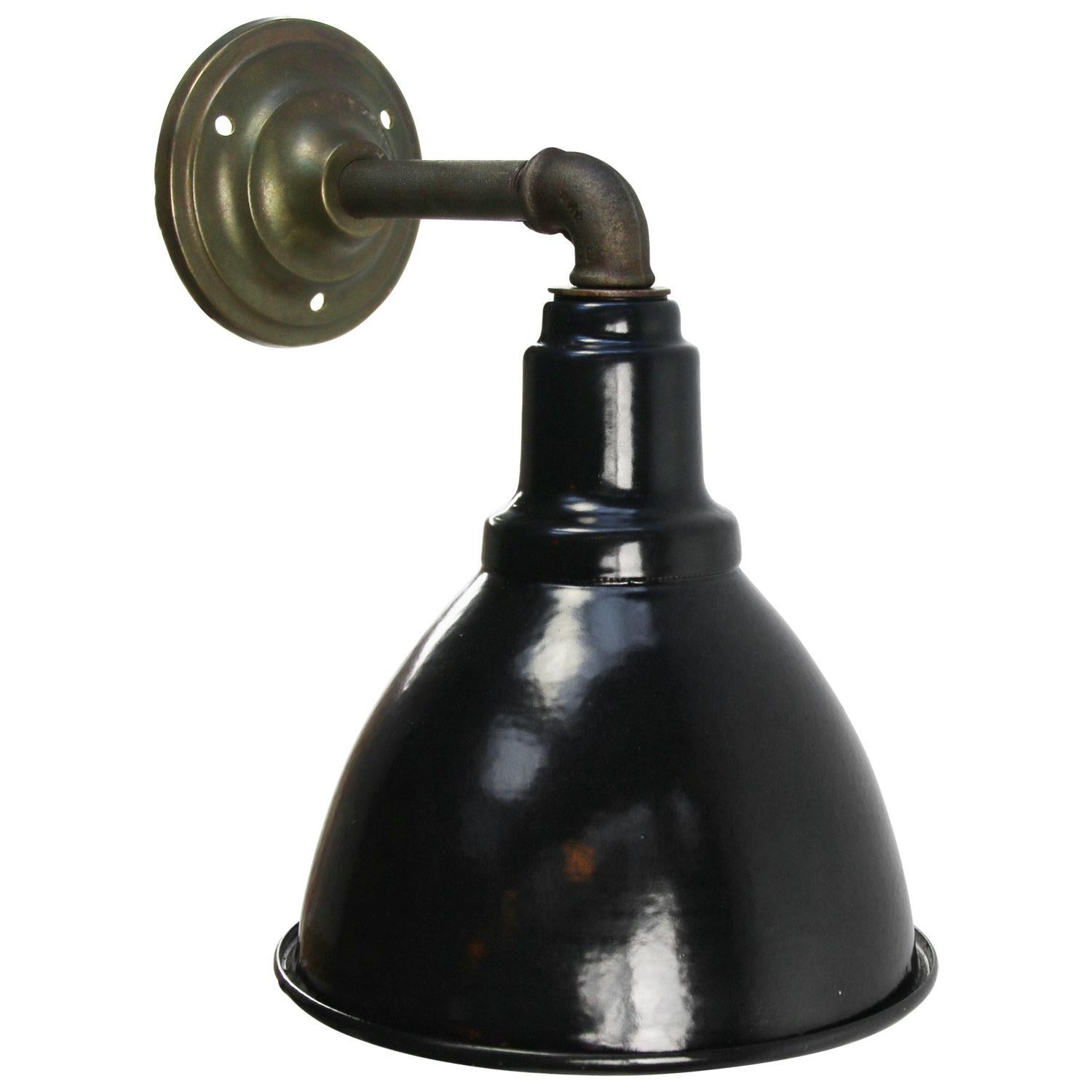 Industrial wall light
Black enamel shade, cast iron arm and brass wall plate

diameter cast iron wall piece: 10 cm, 2 holes to secure

Weight: 1.80 kg / 4 lb

Priced per individual item. All lamps have been made suitable by international
