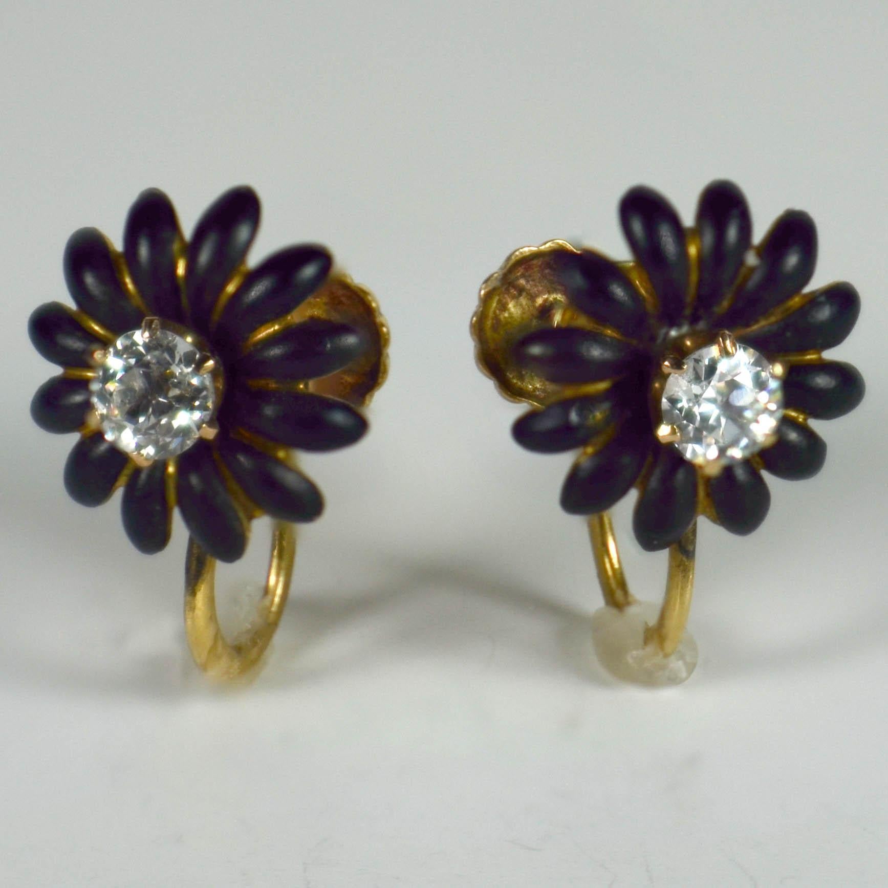 A pair of 10 karat yellow gold screw-back earrings designed as flowers, each with 12 black enamel petals surrounding an Old European Cut white diamond centre.

Marked 10KT.
Total approximate diamond weight 0.80 carats.