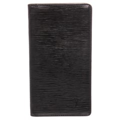 Black Epi leather Louis Vuitton Vertical wallet with debossed logo