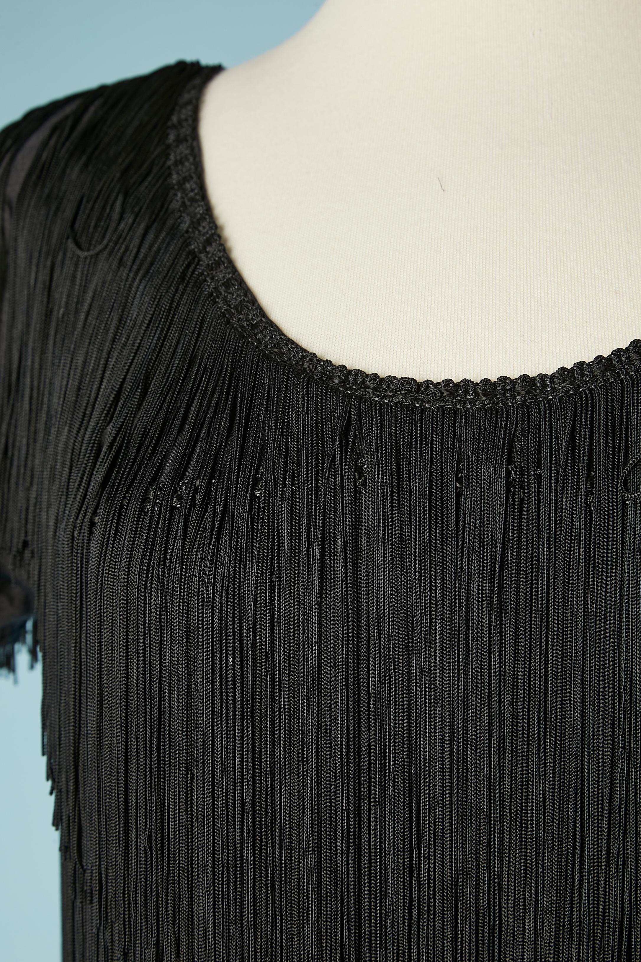 Black evening dress with fringes on Lycra base. Shoulder pad. 
SIZE 38 (Fr) M 