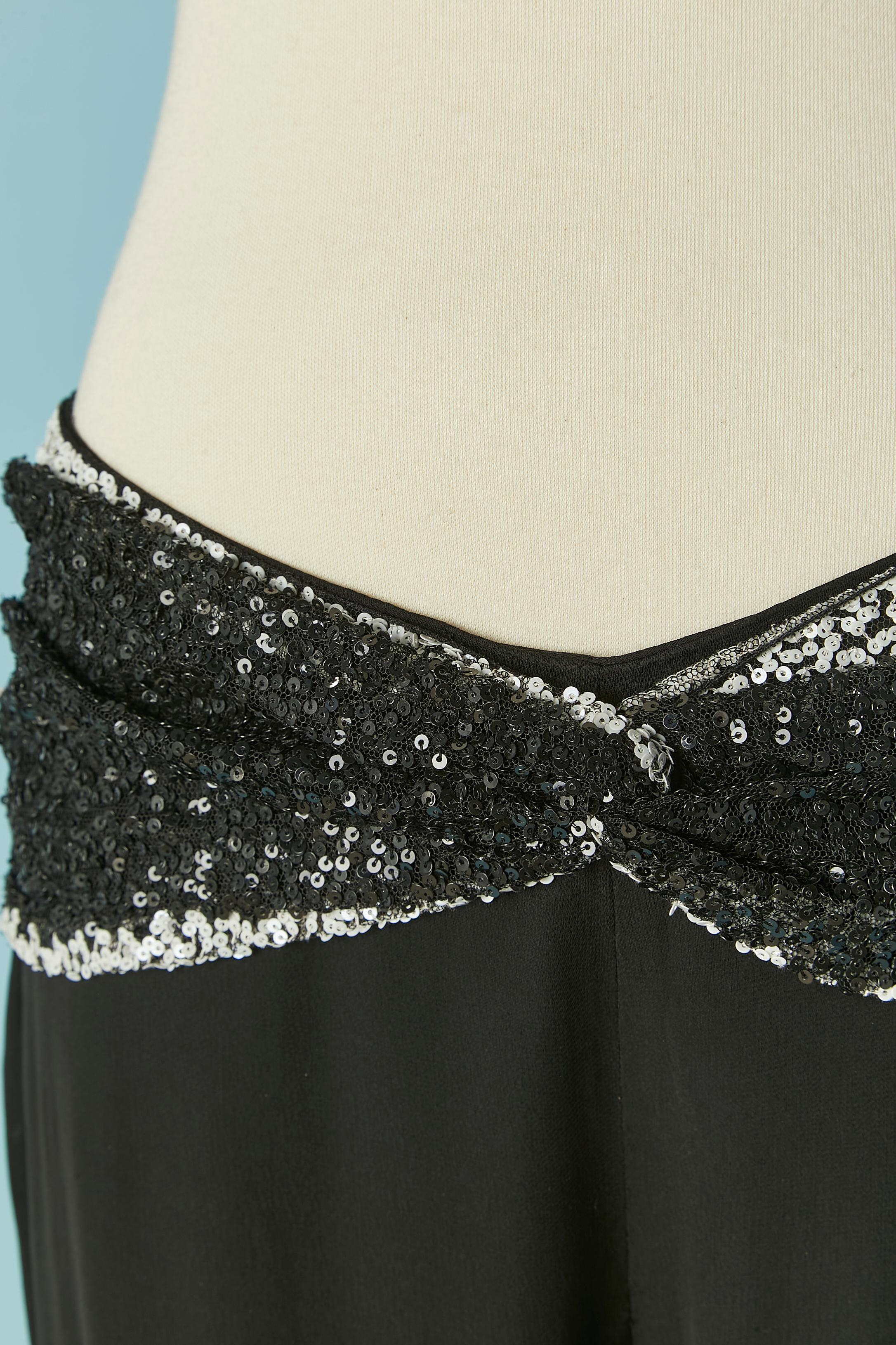 Black evening trouser with draped tulle and sequin belt. 
Main fabric composition: 55% acetate, 30% nylon, 15% silk. 
SIZE 42 (It) L