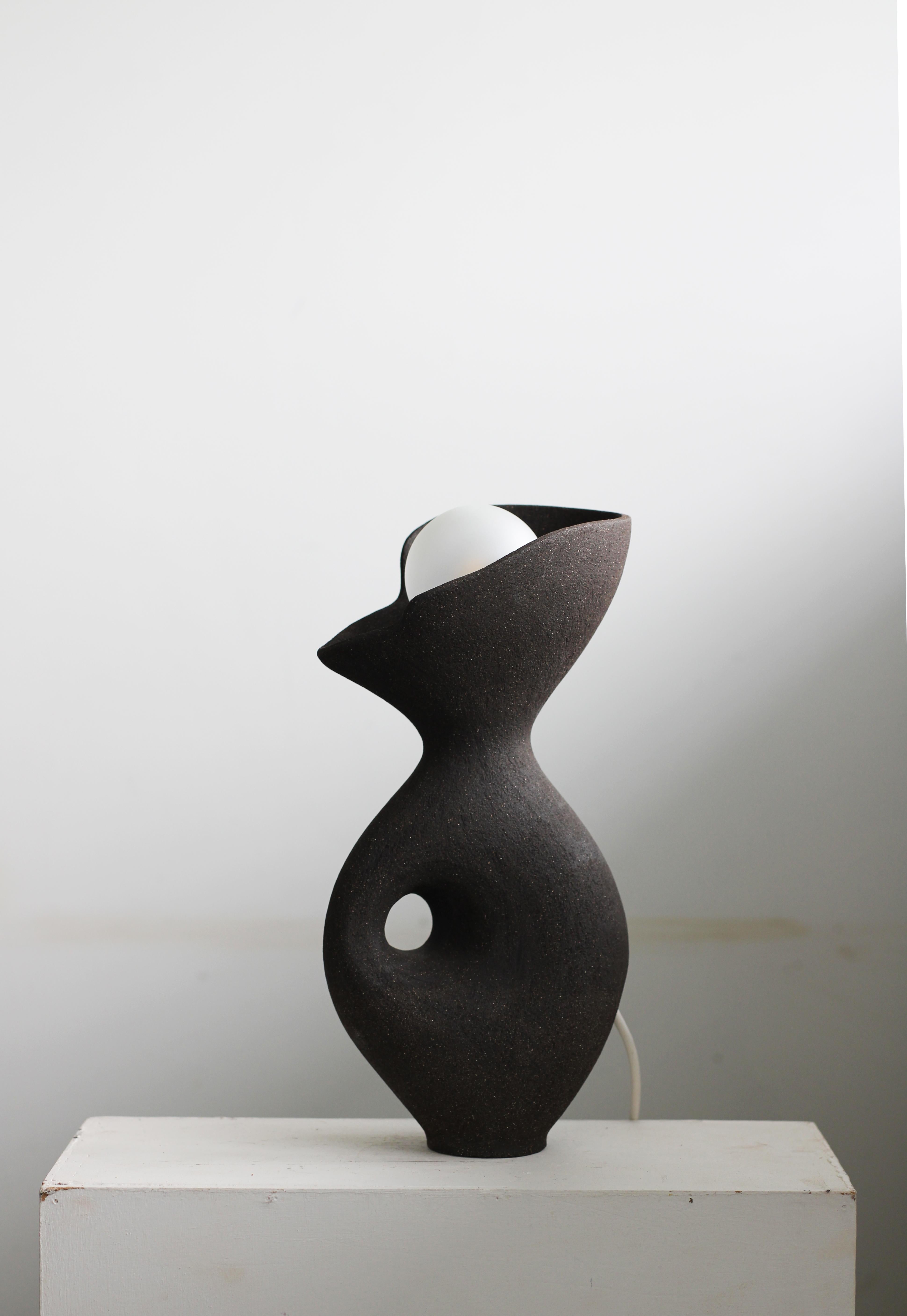 Black Exo Lamp by Abid Javed
Dimensions: W 20 x 32 H cm (Dimensions are variable)
Materials: Stoneware ceramic, Brass.
Multiple clay color and size options.

Coiled hollow form with a non-glazed ceramic surface. Bulb optional.
 All our lamps