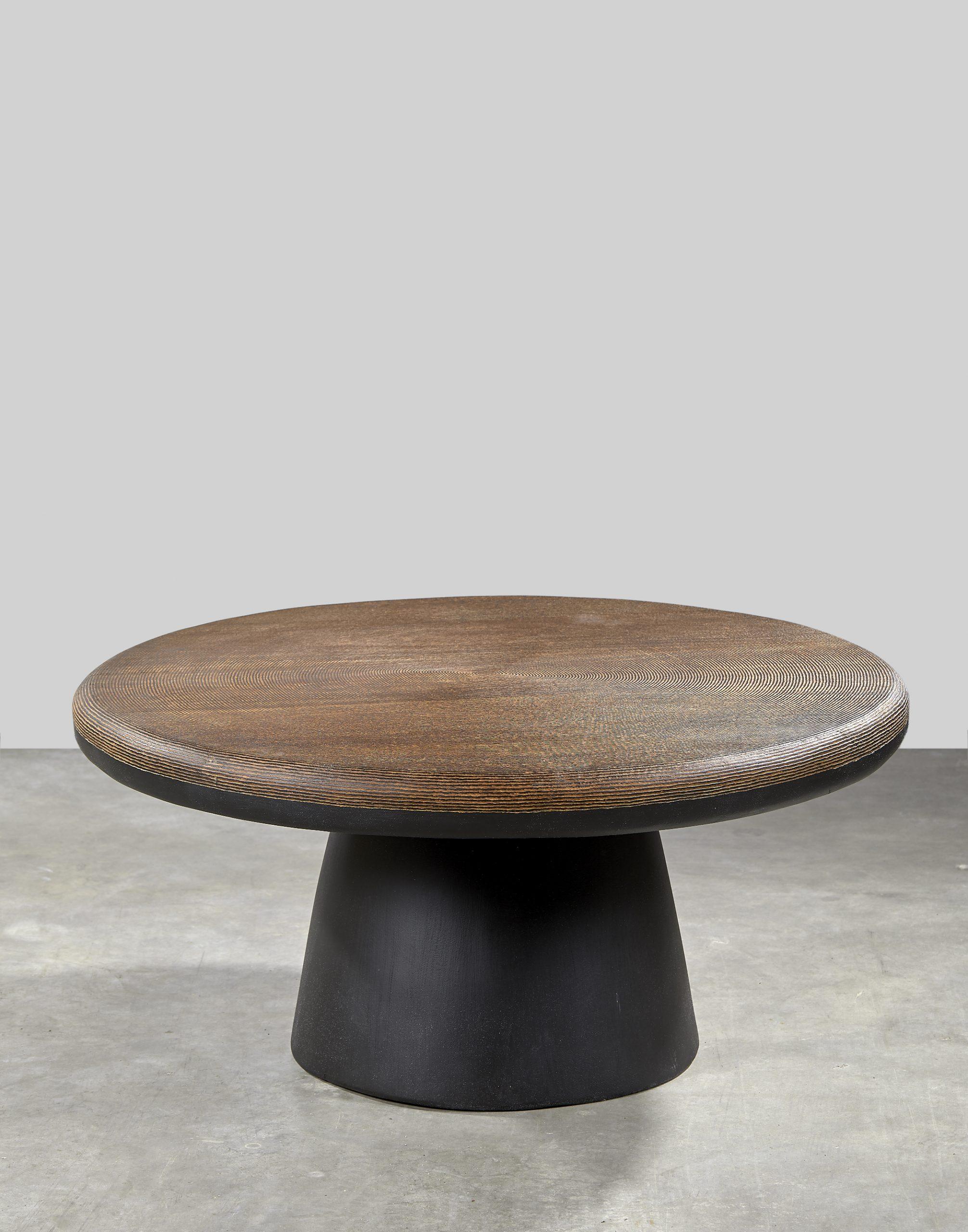 Layou coffee table 
Dimensions: Diameter 90 cm / Height 35 cm
Materials: Dimb wood (exotic African wood) with hand carved top.
Legs carved from the tree trunk.
Each edition of the Layou coffee table is a unique piece

Over the years, Papa Mamadou