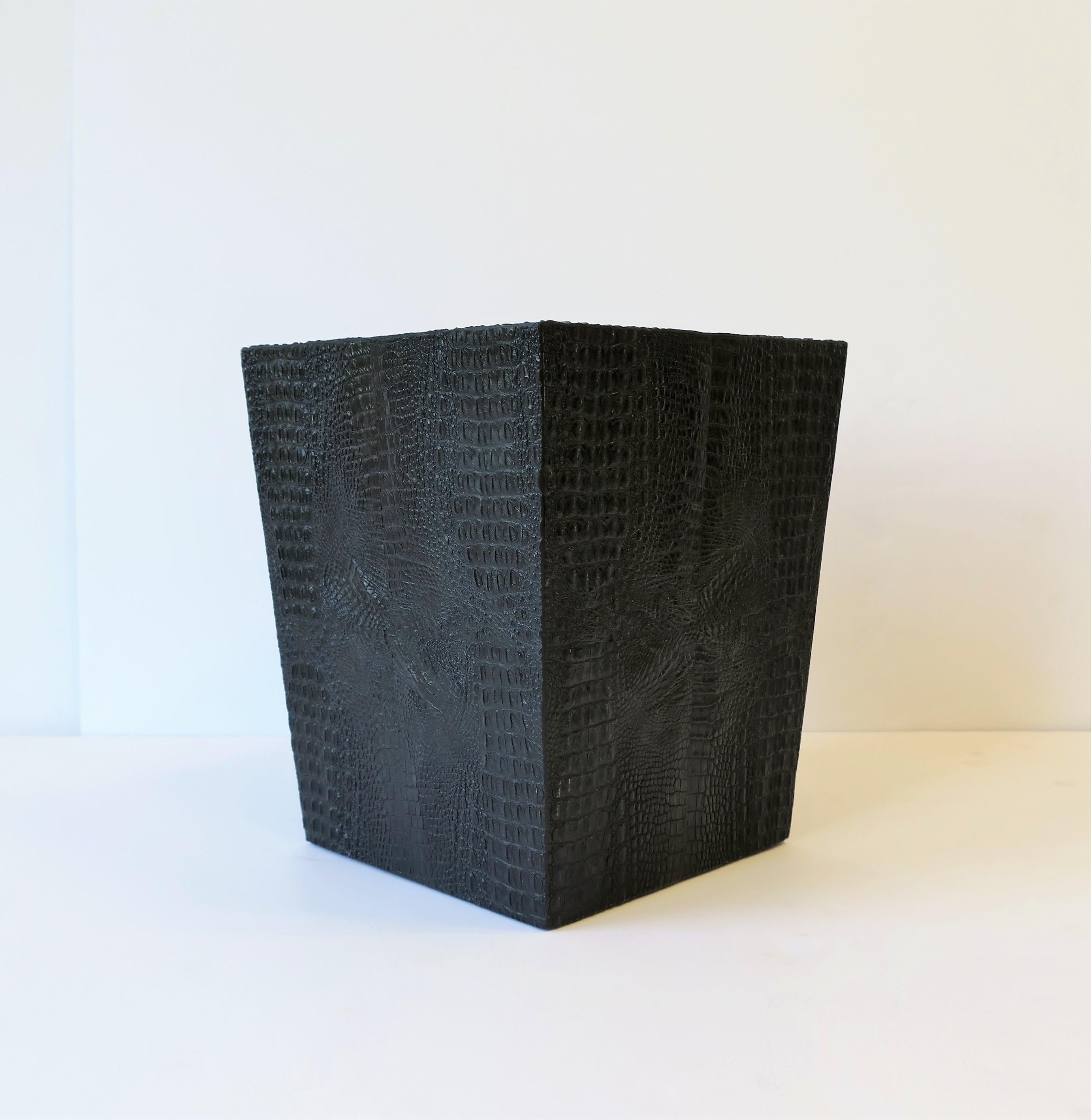 A beautiful black wastebasket [waste basket] or trash can with an embossed faux alligator or crocodile design. 

Piece measures: 9 in. square x 10.75 in. H