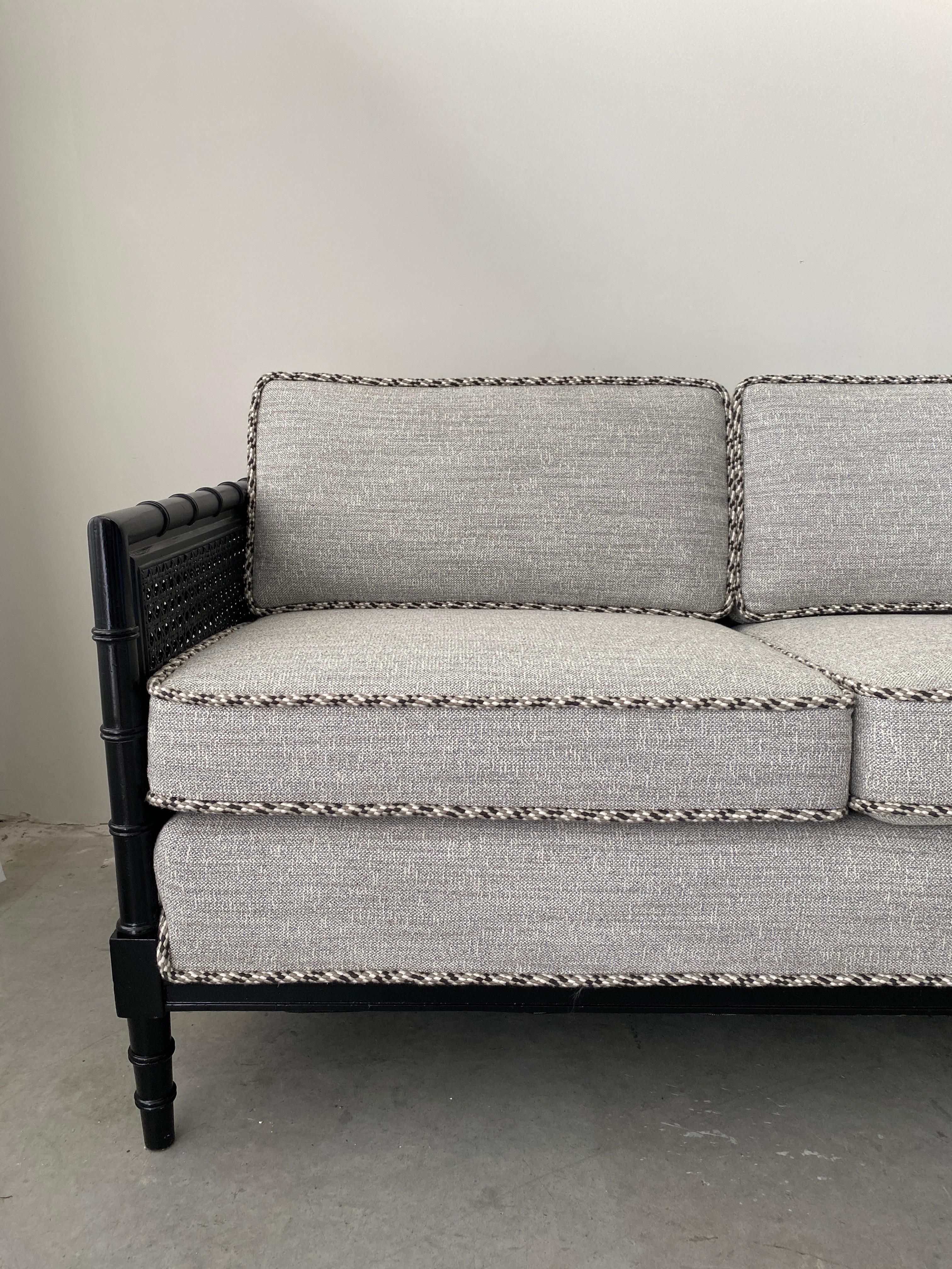Listed is a fabulous, Henredon faux bamboo settee, circa 1970s. The piece has been professionally upholstered with new fabric and cording from Scalamandré's newest 'Pacifica Collection'. The fabric is absolutely stunning in person, with its textural