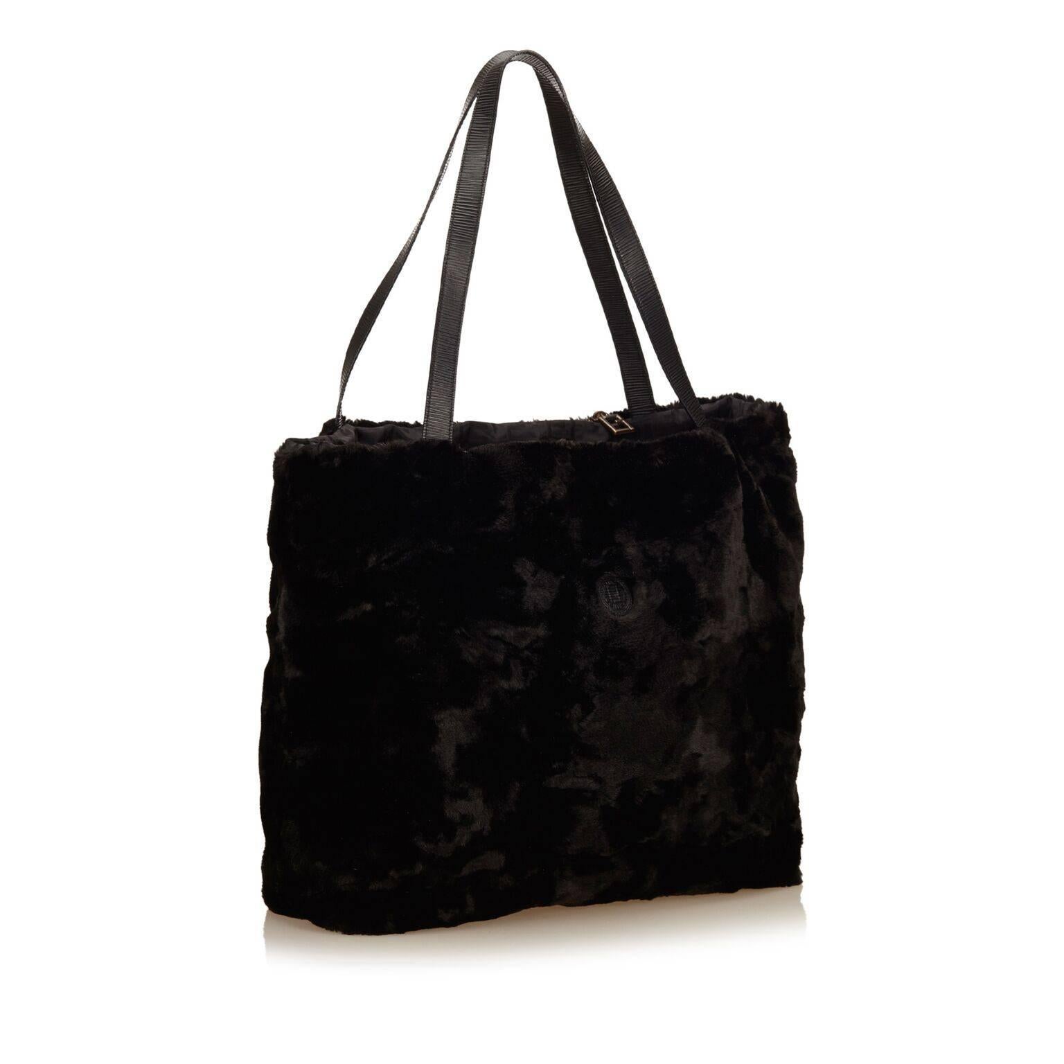 Product details:  Black fur tote bag by Fendi.  Dual leather shoulder straps.  Open top.  Lined interior.  22