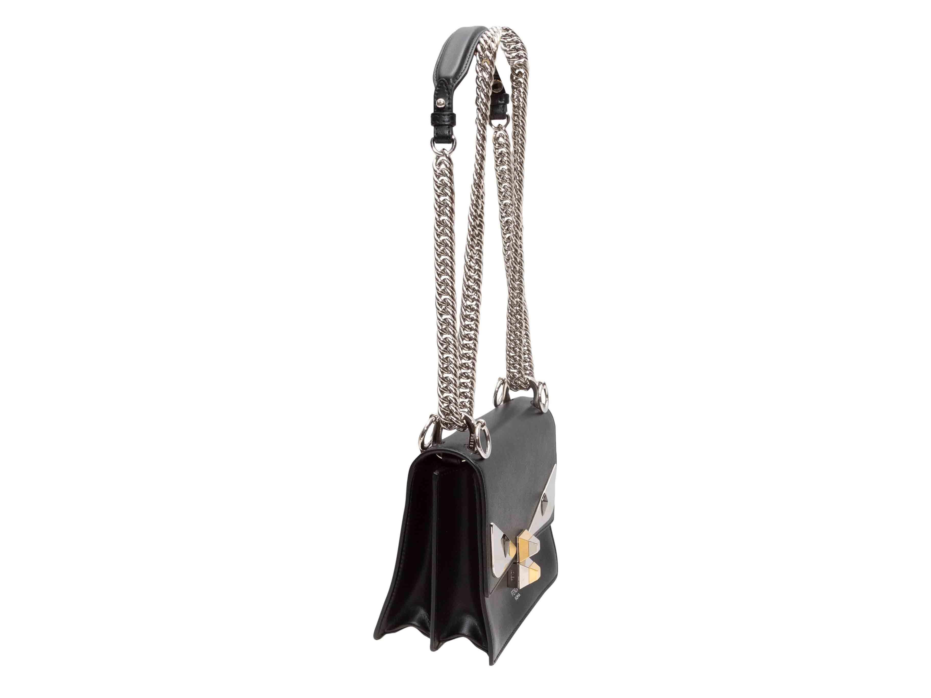Black Fendi Monster Crossbody Bag. The Monster Crossbody Bag features a leather body, silver-tone hardware, a chain-link and leather shoulder strap, and a front flap closure. 7.4