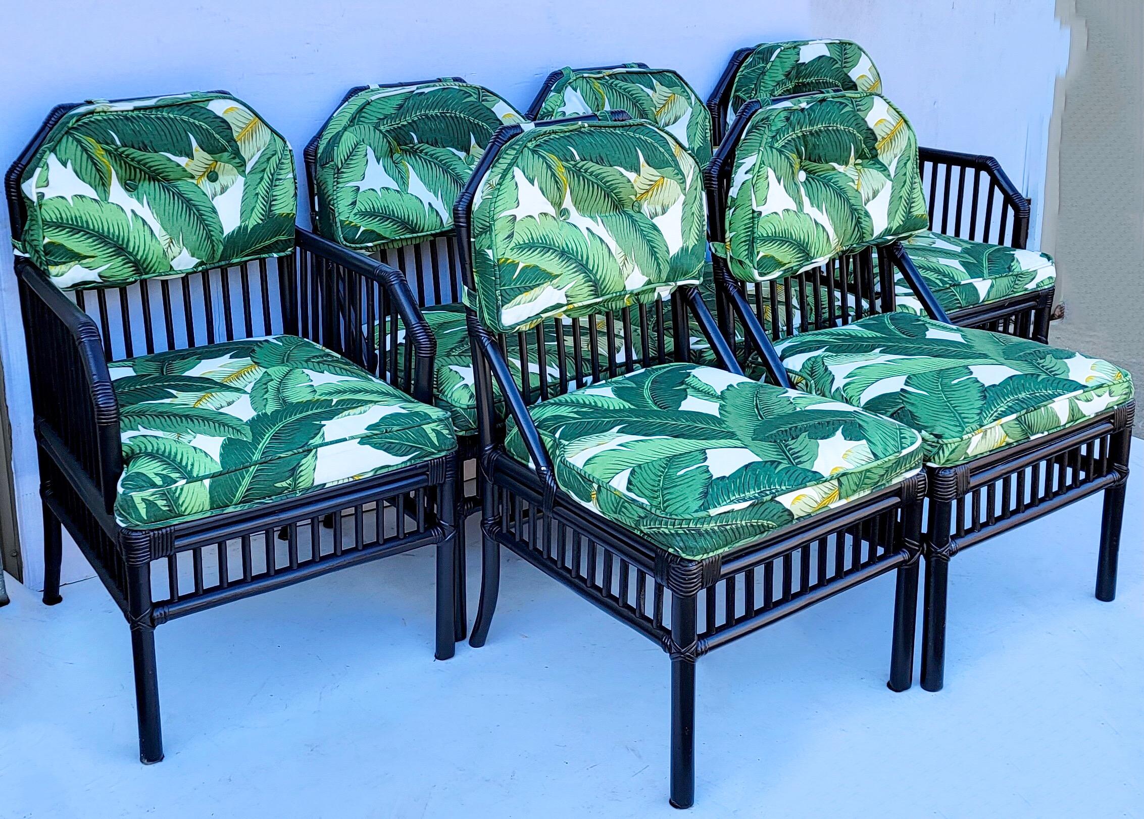 This is a fun set! It is a set of 6 black rattan dining chairs by Ficks Reed. The upholstery is an indoor outdoor banana leaf. Side : 20”L x 23”W x 34”H.