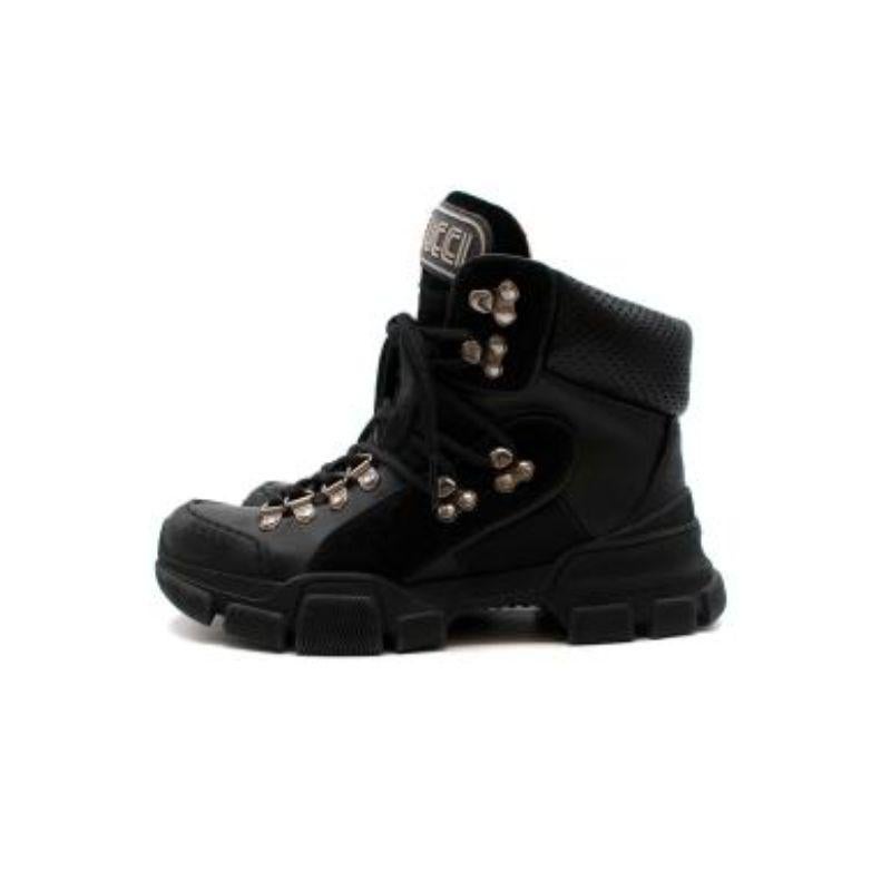 Gucci Black Flashtrek Ankle Boots
 
 - Black Flashtrek Logo-appliquéd Suede, Leather And Canvas Ankle Boots
 - Thick rubber soles
 - Cushioned section to support the ankle
 - Large logo patch on the tongues
 - Laced fronts with hooks
 
 Materials
