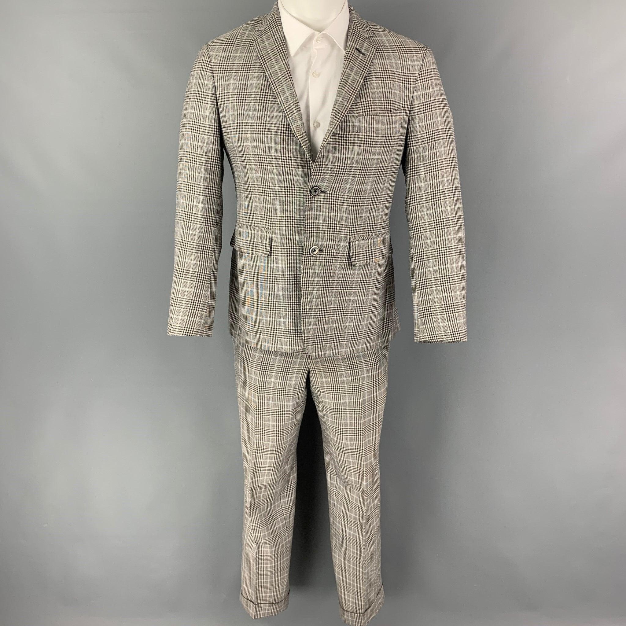 BLACK FLEECE
suit comes in a black & white glenplaid wool blend with a full liner and includes a single breasted, three button sport coat with a notch lapel and matching flat front trousers. Very Good Pre-Owned Condition. 

Marked:   BB1