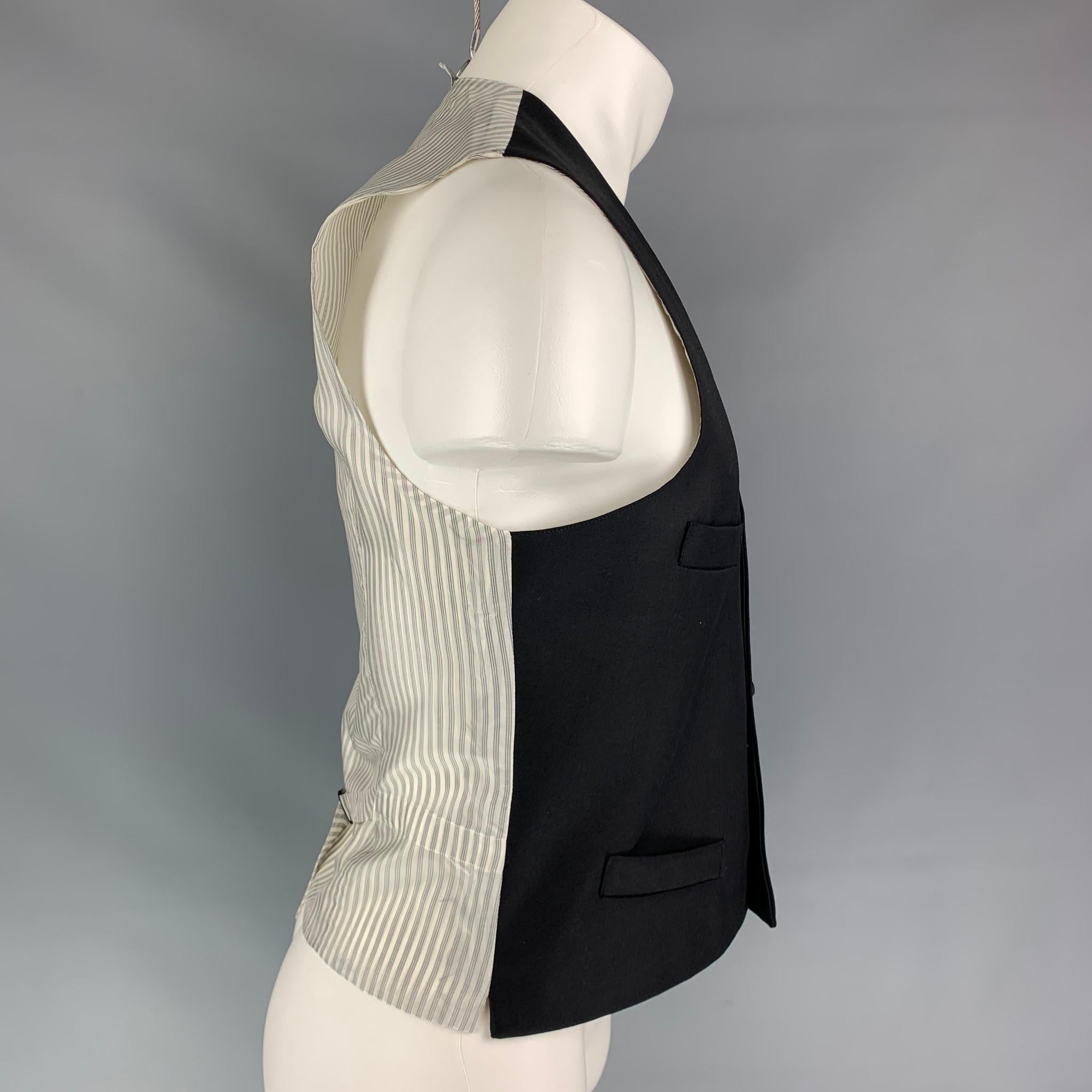 BLACK FLEECE vest comes in a black wool with a stripe back featuring a back belt, slit pockets, and a buttoned closure. Made in USA. 

Very Good Pre-Owned Condition.
Marked: BB1

Measurements:

Shoulder: 13.5 in.
Chest: 38 in.
Length: 23 in. 