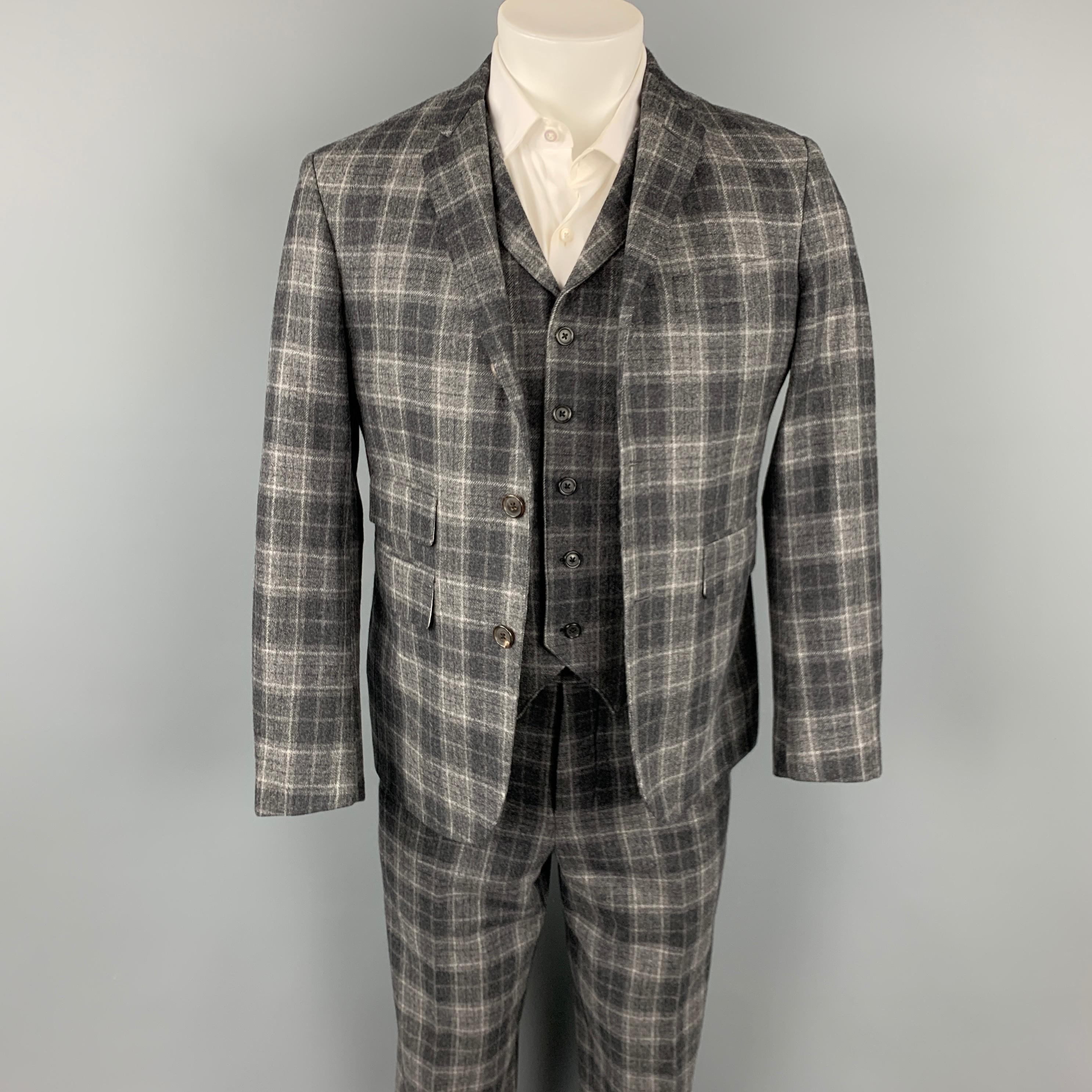 BLACK FLEECE 3 Piece suit comes in a dark gray plaid wool / cashmere with a full liner and includes a single breasted, three button sport coat with a notch lapel. Includes, matching flat front trousers and vest. Made in USA.

Very Good Pre-Owned