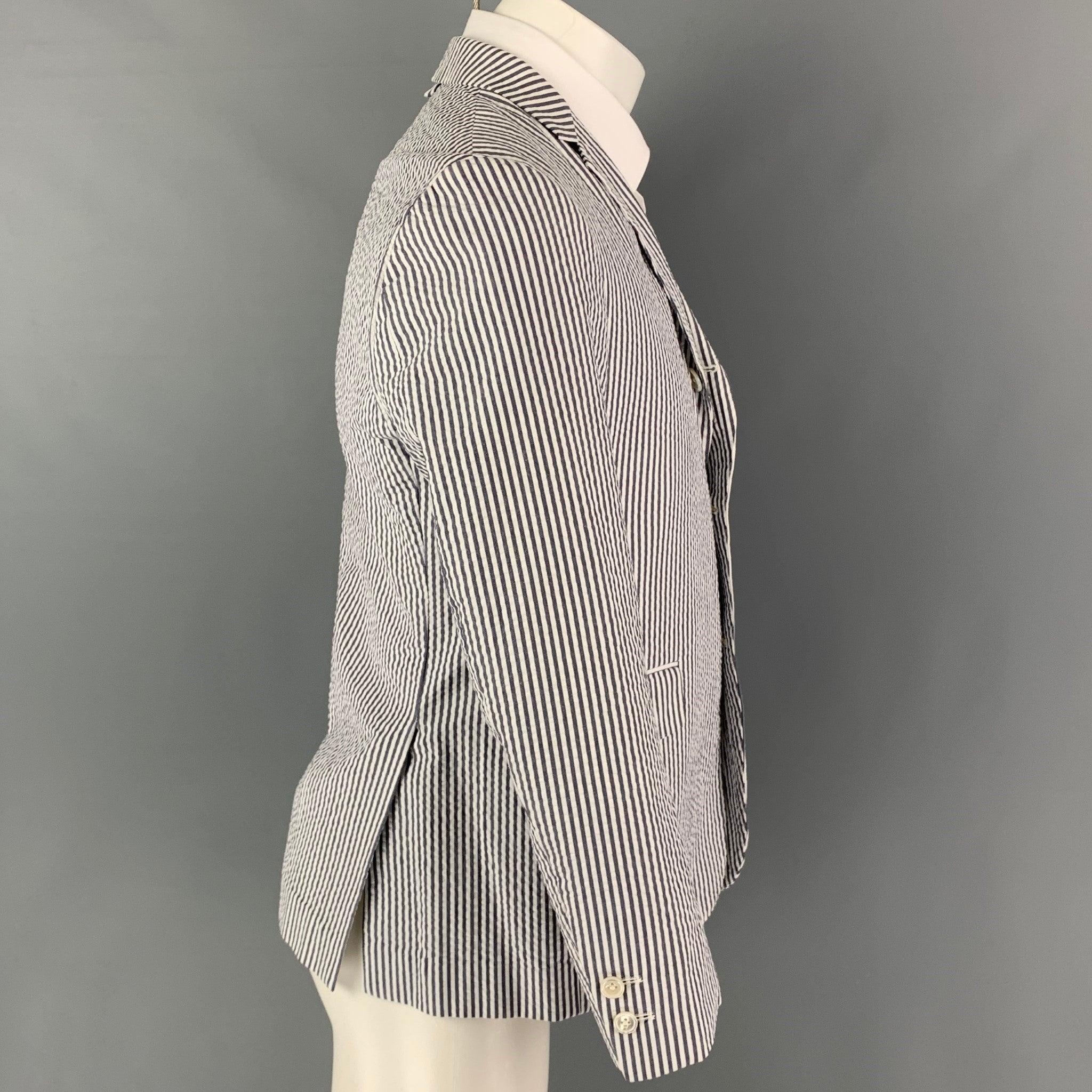 BLACK FLEECE sport coat comes in a white & grey seersucker cotton featuring a notch lapel, flap pockets, double back vent, and a three button closure.
Very Good
Pre-Owned Condition.  

Marked:   BB1 

Measurements: 
  
Shoulder: 17 inches Chest:
38