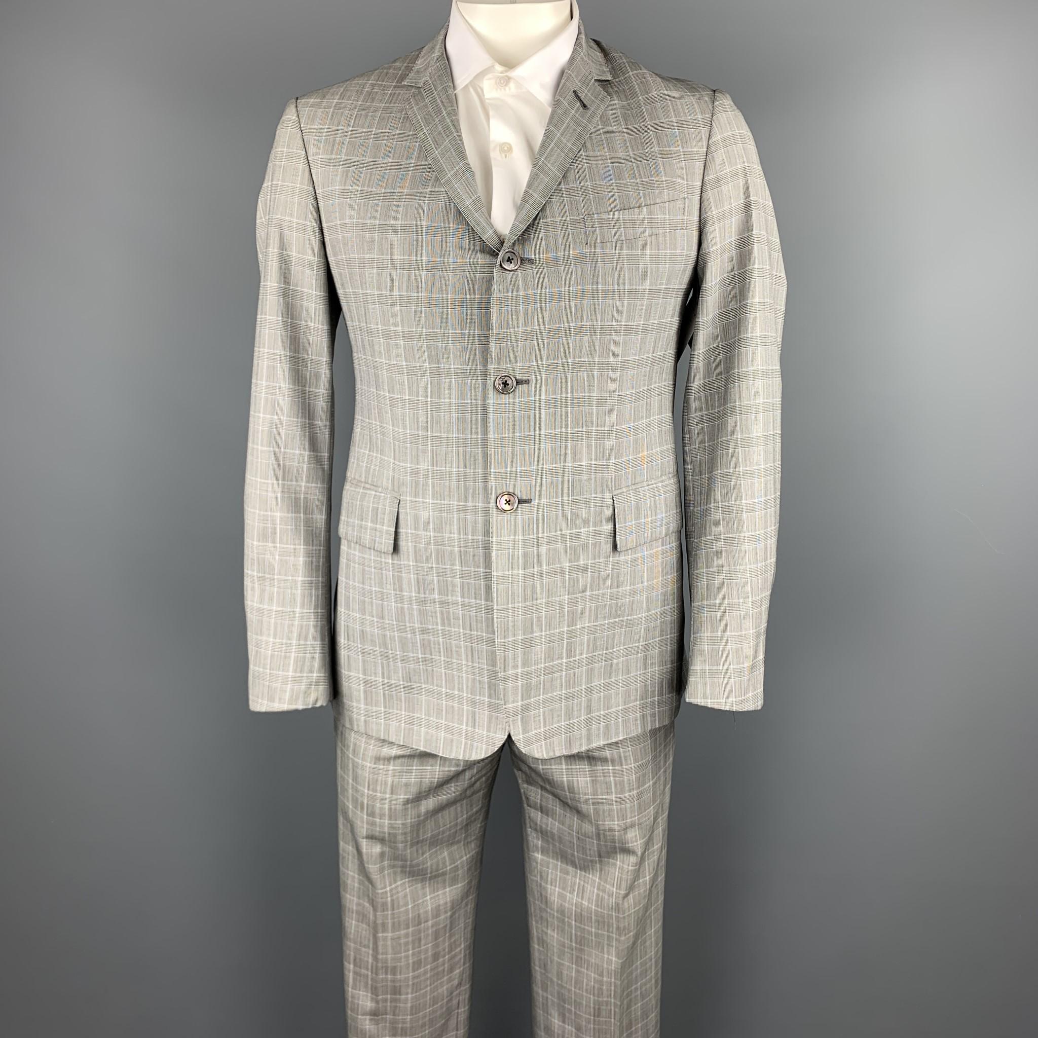 BLACK FLEECE suit comes in a gray glenplaid wool and includes a single breasted, three button sport coat with a notch lapel and matching flat front trousers. Made in Italy. 

Excellent Pre-Owned Condition.
Marked: BB