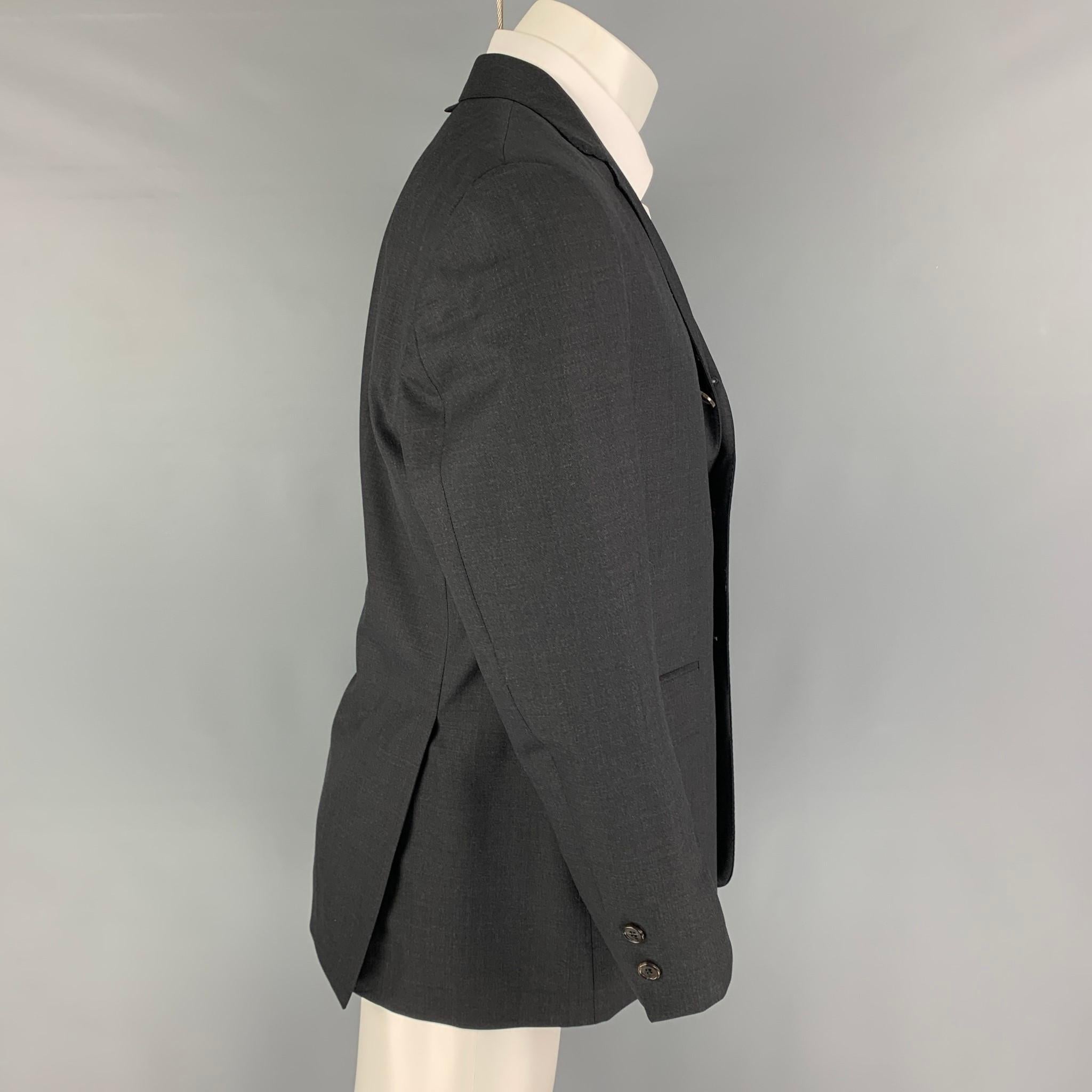 BLACK FLEECE sport coat comes in a charcoal wool  with a full liner featuring a notch lapel, flap pockets, double back vent, and a three button closure. Made in USA. 

Excellent Pre-Owned Condition.
Marked: 40

Measurements:

Shoulder: 18 in.
Chest: