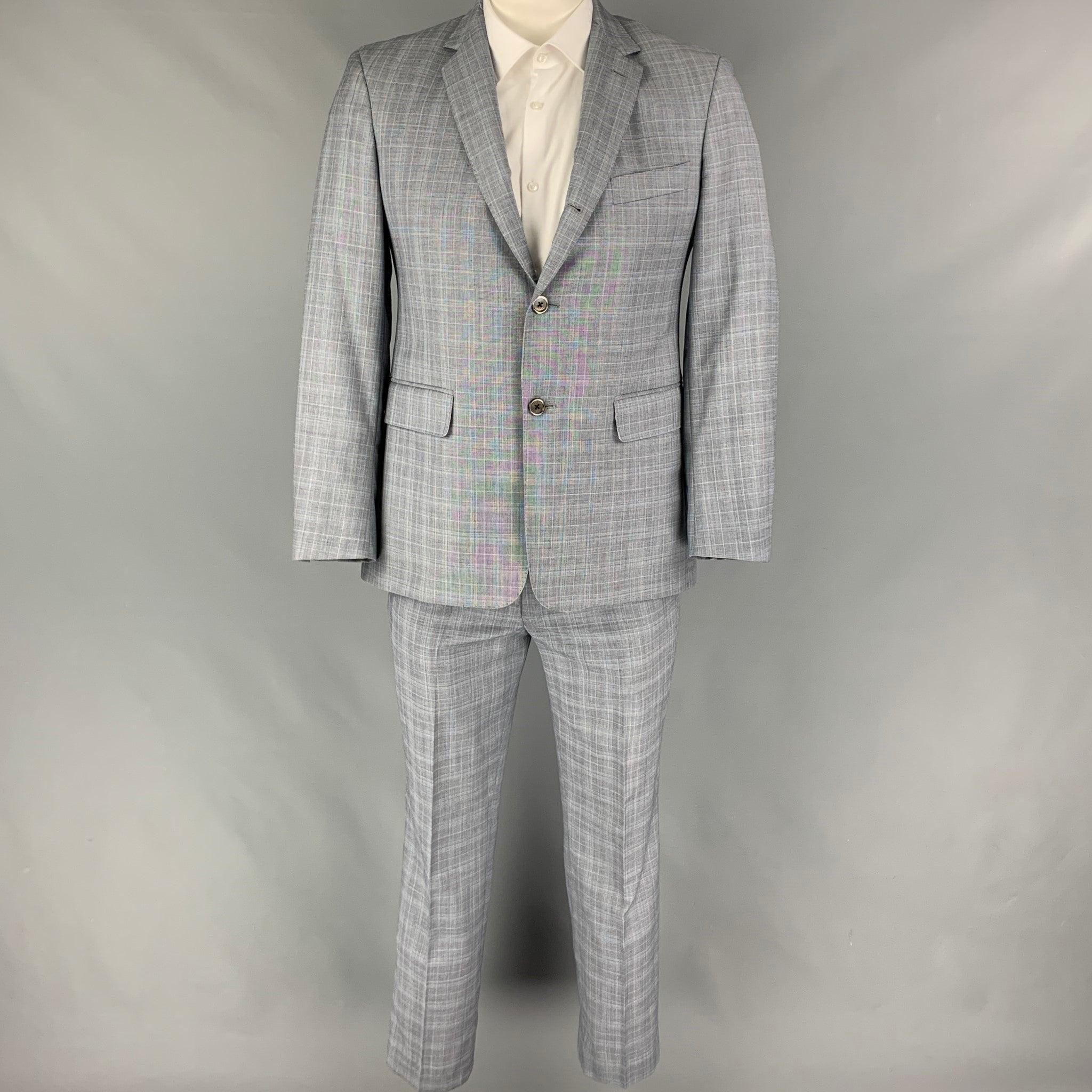 BLACK FLEECE
suit comes in a grey plaid wool with a full liner and includes a single breasted, three button sport coat with a notch lapel and matching flat front trousers. Made in USA. Very Good Pre-Owned Condition. 

Marked:   BB2 

Measurements: 
