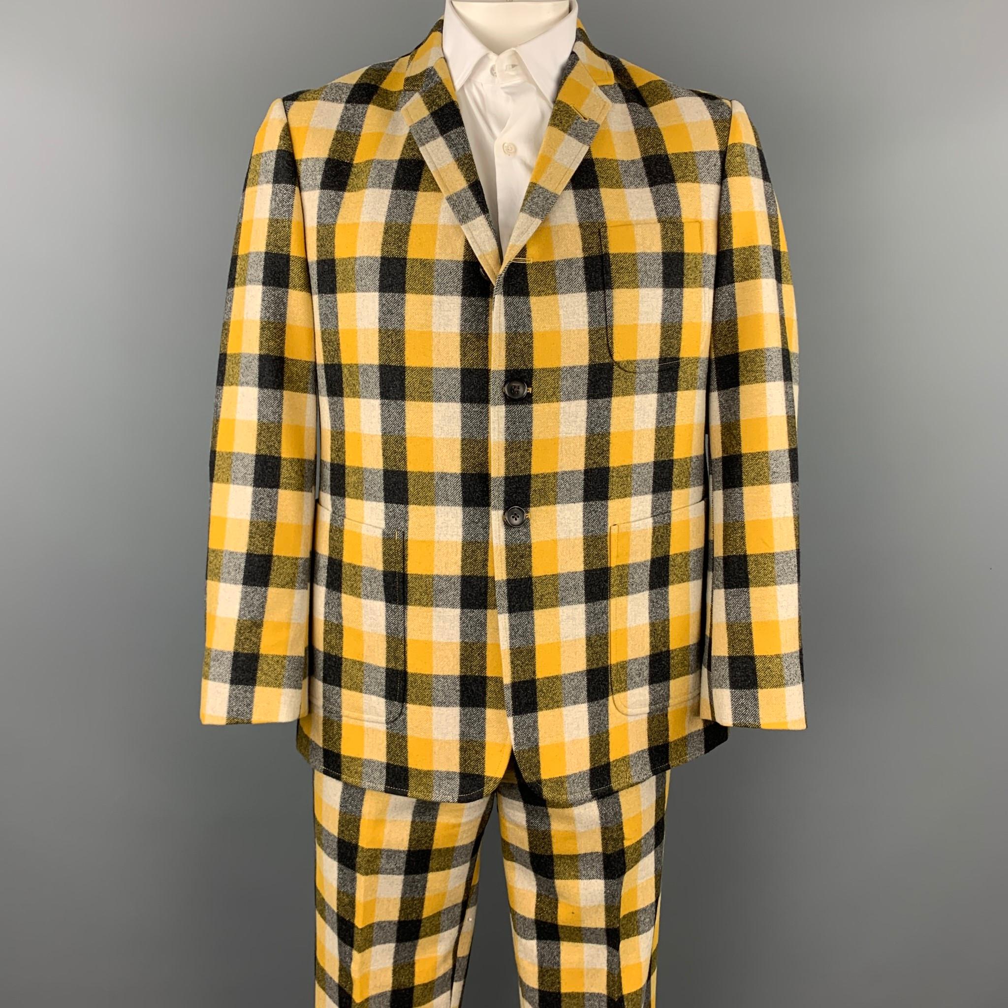 BLACK FLEECE suit comes in a yellow & grey plaid wool with a half liner and includes a single breasted, three button sport coat with a notch lapel and matching flat front trousers.

Very Good Pre-Owned Condition.
Marked: