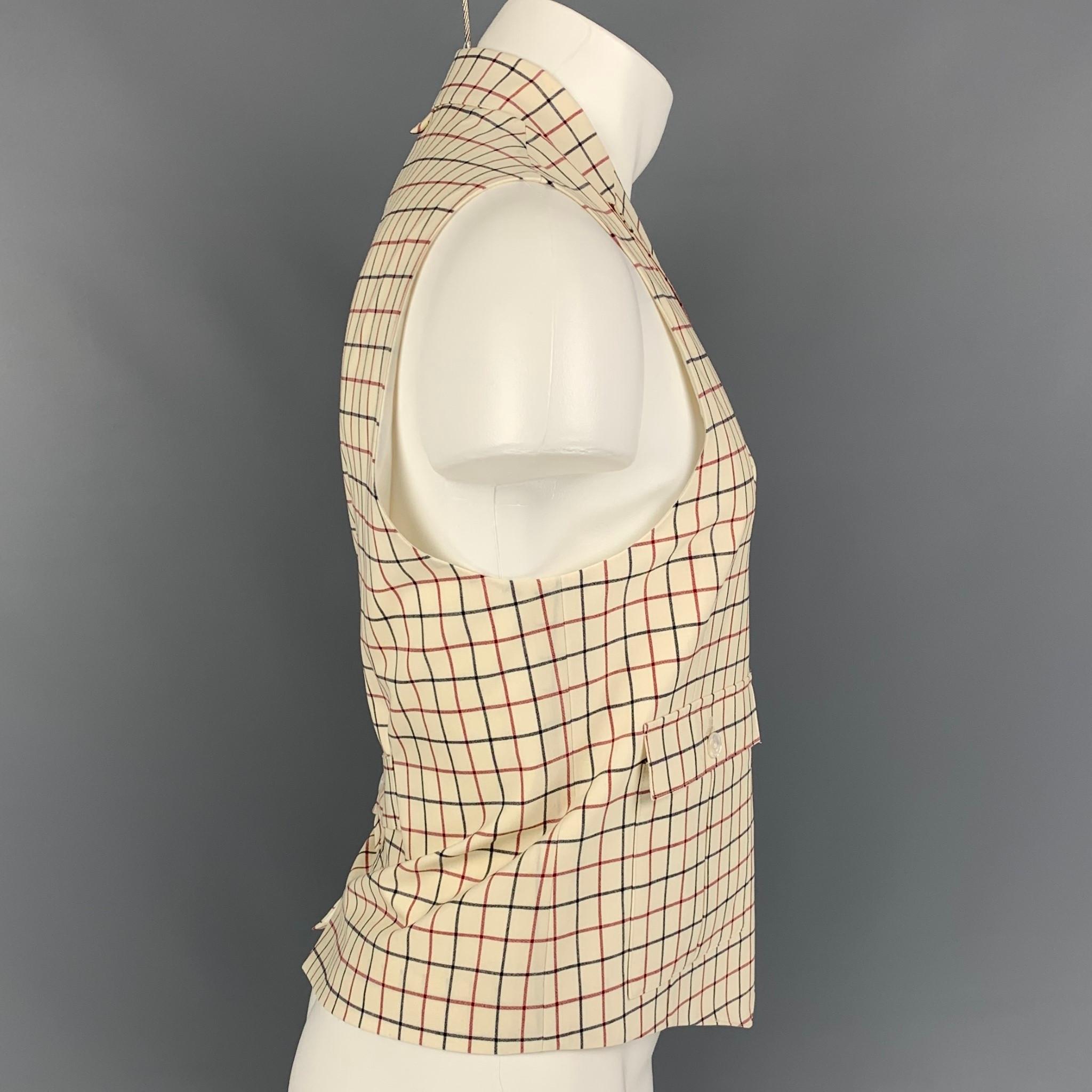 BLACK FLEECE vest comes in a beige & navy window pane wool featuring a notch lapel, back belt, patch pockets, and a buttoned closure. 

New With Tags. 
Marked: BB2

Measurements:

Shoulder: 15 in.
Chest: 42 in.
Length: 23 in. 