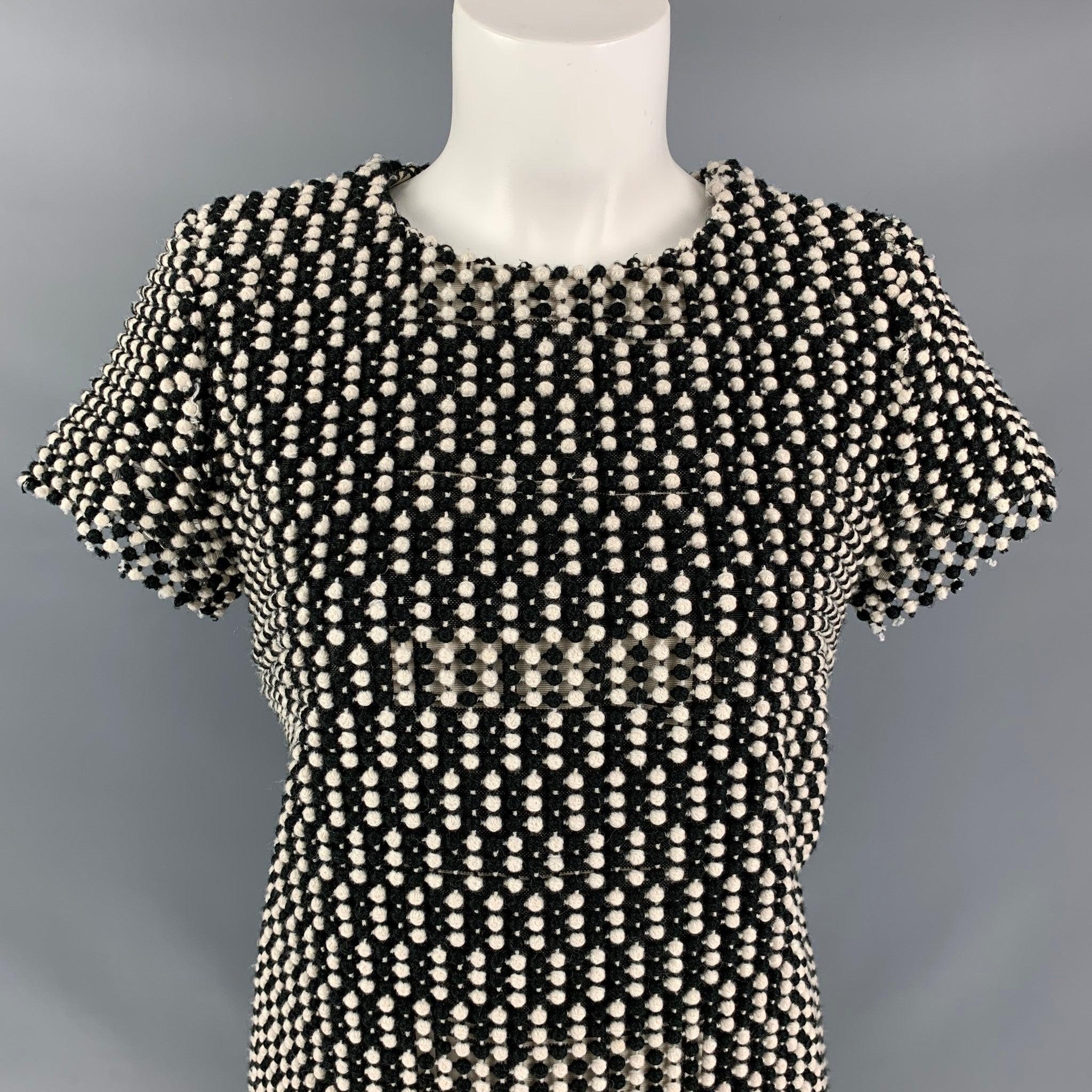 BLACK FLEECE by Thom Browne below knee dress comes in black and white wool blend featuring texture all over the garment. Made in Romania
Excellent Good Pre-Owned Condition.  

Marked:   42 

Measurements: 
 
Shoulder: 14.5 inBust: 36 inWaist: 36