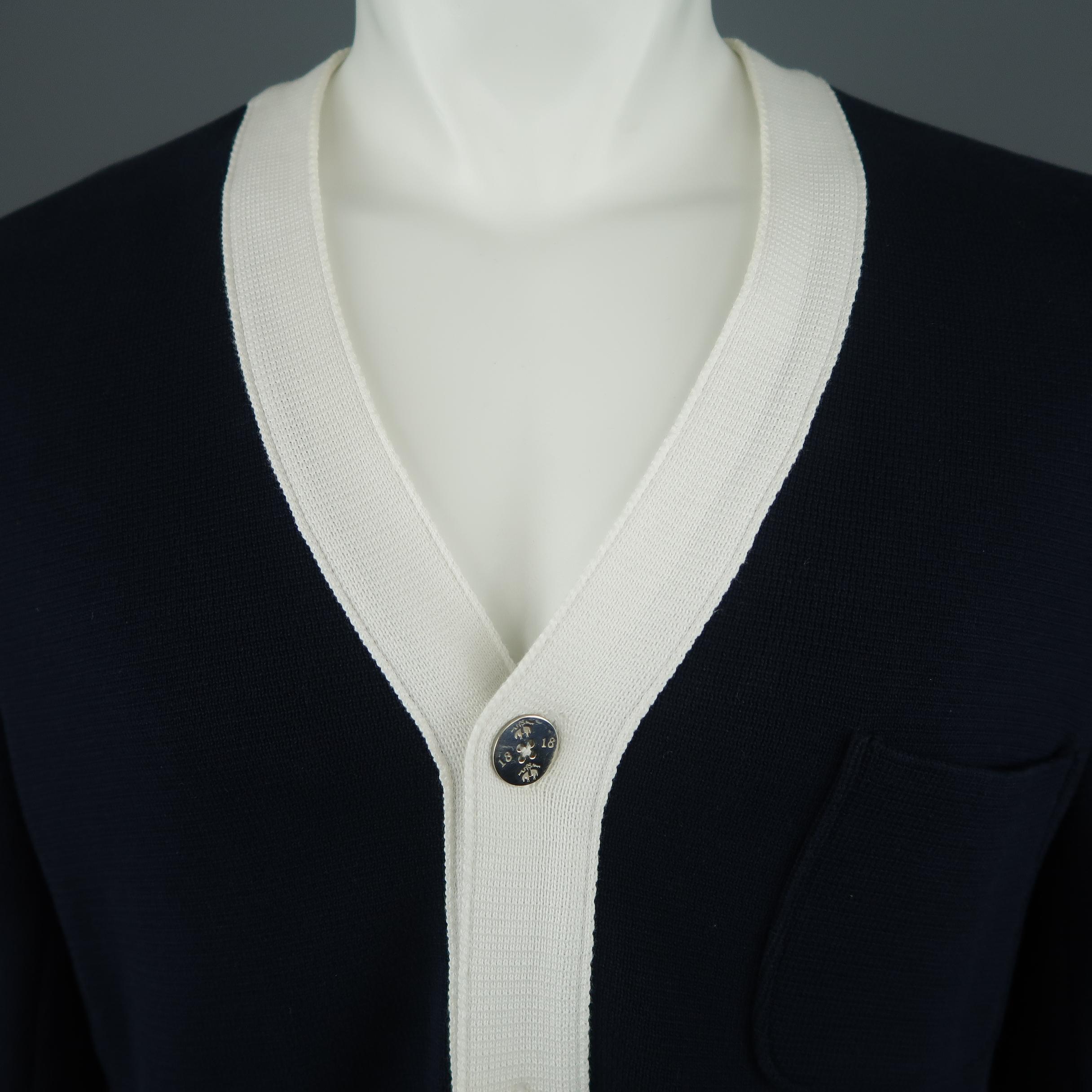 BROOKS BROTHERS cardigan comes in navy cotton knit with thick white trim, three patch pockets, and three silver tone metal buttons. Retail price $550,00. 
 
Excellent Pre-Owned Condition.
Marked: BB1
 
Measurements:
 
Shoulder: 18 in.
Chest: 44