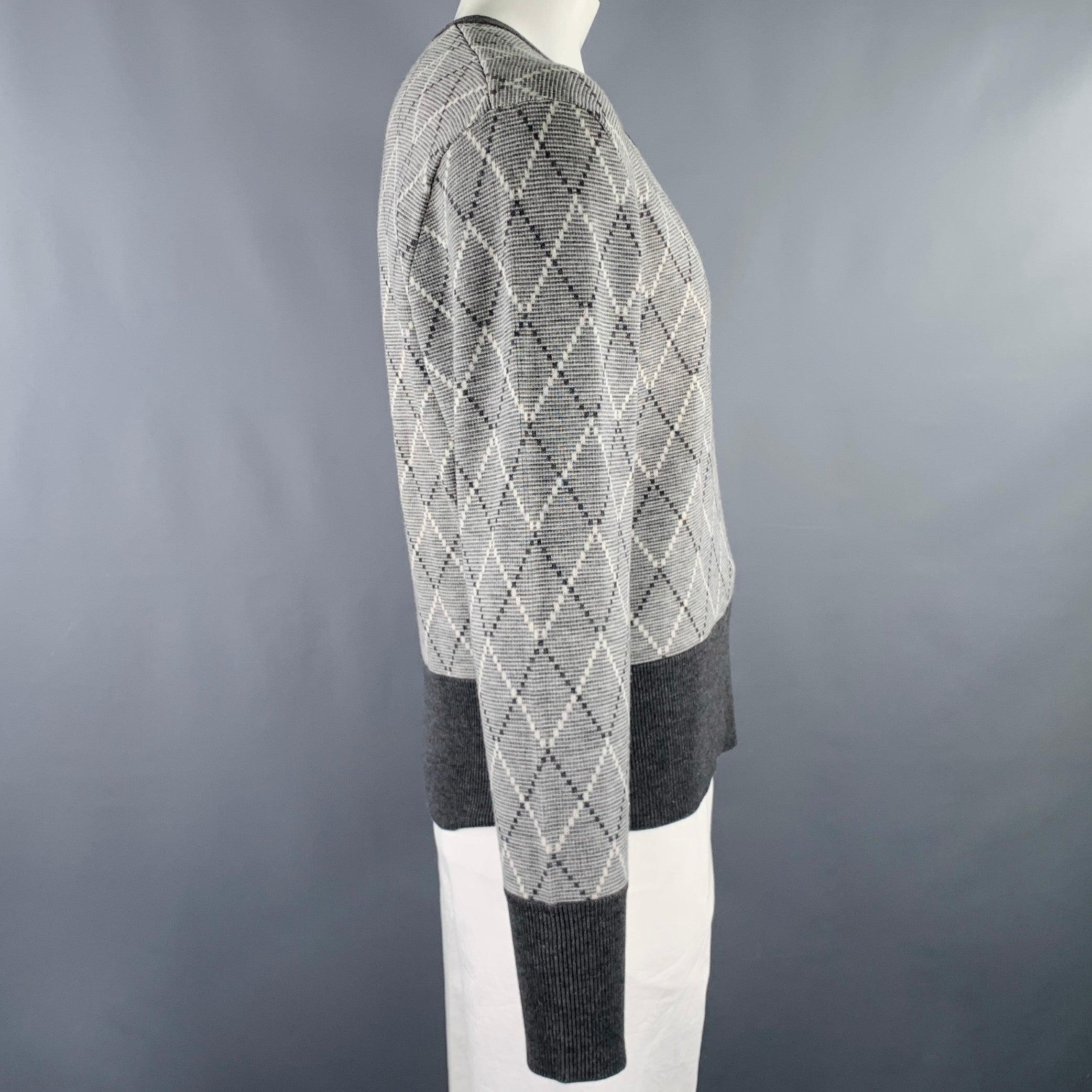 BLACK FLEECE pullover in a grey and white wool blend knit fabric featuring a diamond pattern, long sleeves with button cuffs, and V-neck.Very Good Pre-Owned Condition. Minor repair on right shoulder. As is. 

Marked:   BB5 

Measurements: 
