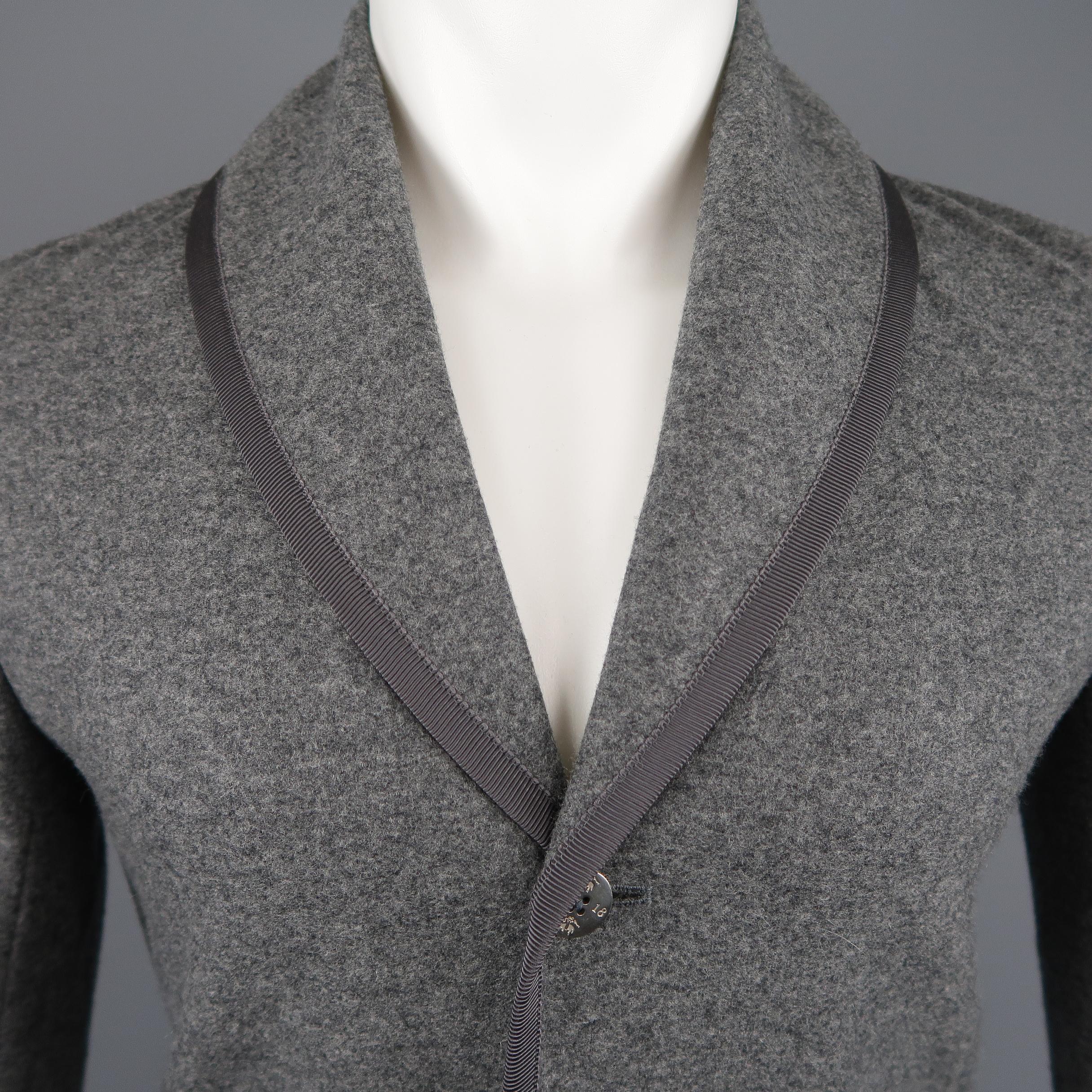 BLACK FLEECE jacket comes in dark heather gray wool blend fabric with a shawl collar, grosgrain piping, patch pockets, and metal embossed buttons. Retail price $1,200.00 
 
Excellent Pre-Owned Condition.
Marked: BB0
 
Measurements:
 
Shoulder: 17