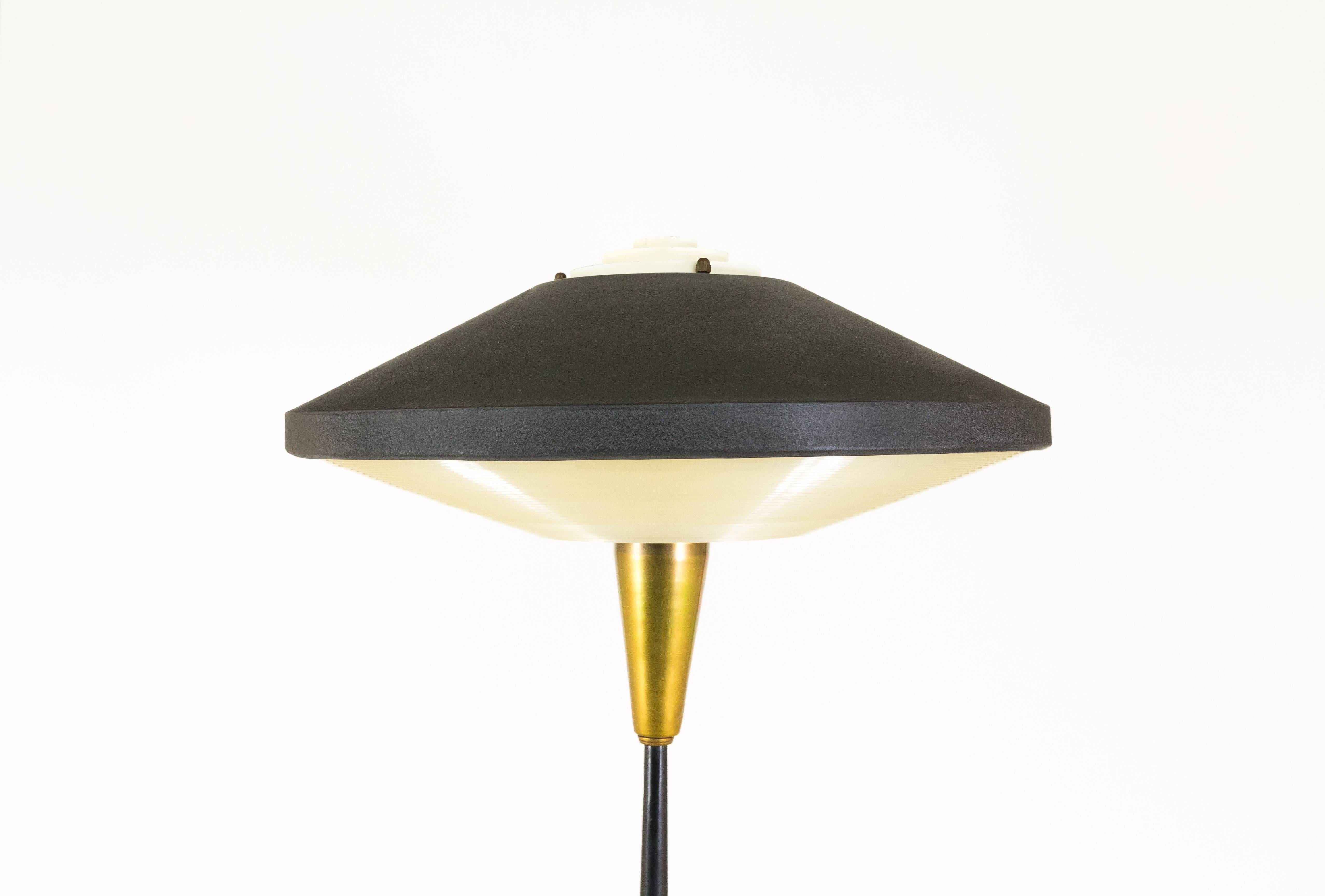 A rare floor lamp NX 546 E/00 by Louis Kalff for Philips Eindhoven. Equipped with a black coated metal hood, with a small metal diffuser in the middle and at the bottom of the hood a Plexiglass diffuser. This allows the light to spread nicely at