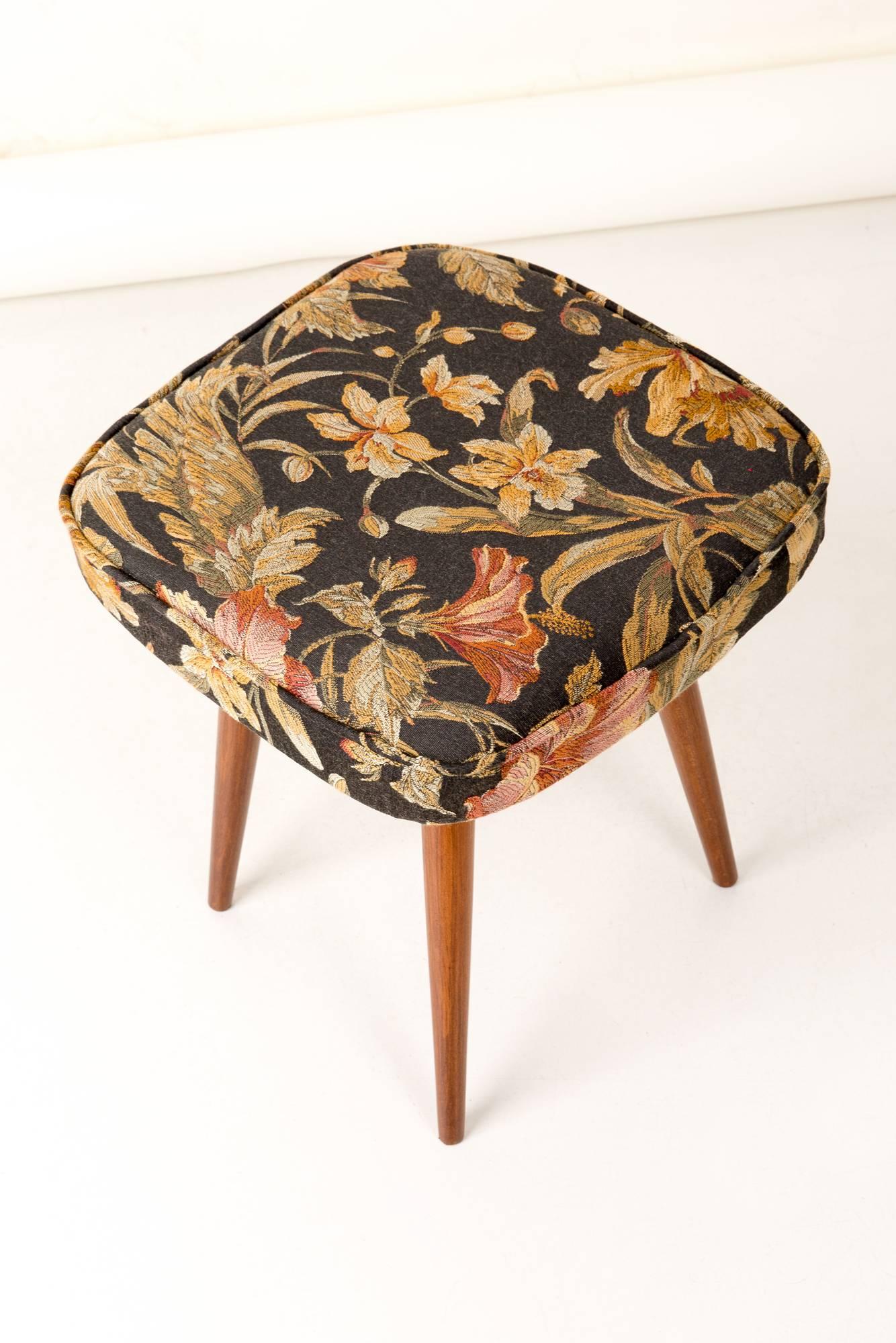 Stool from the turn of the 1960s and 1970s. Beautiful black floral upholstery. The stool consists of an upholstered part, a seat and wooden legs narrowing downwards, characteristic of the 1960s style. We can prepare this stool also in another option