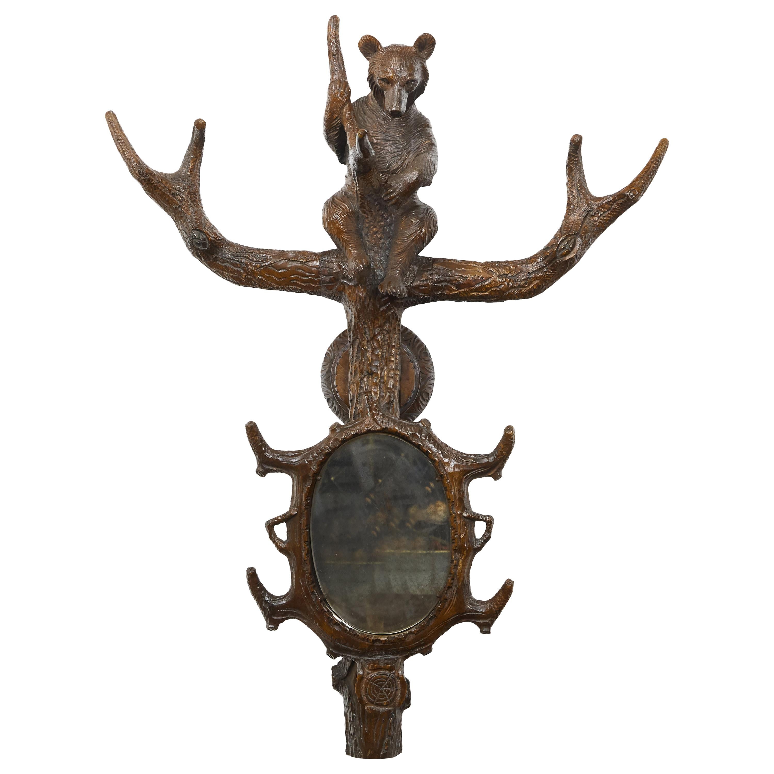 Black Forest 1900s Carved Wooden Wall Hanging Ornament with Bear and Oval Mirror For Sale