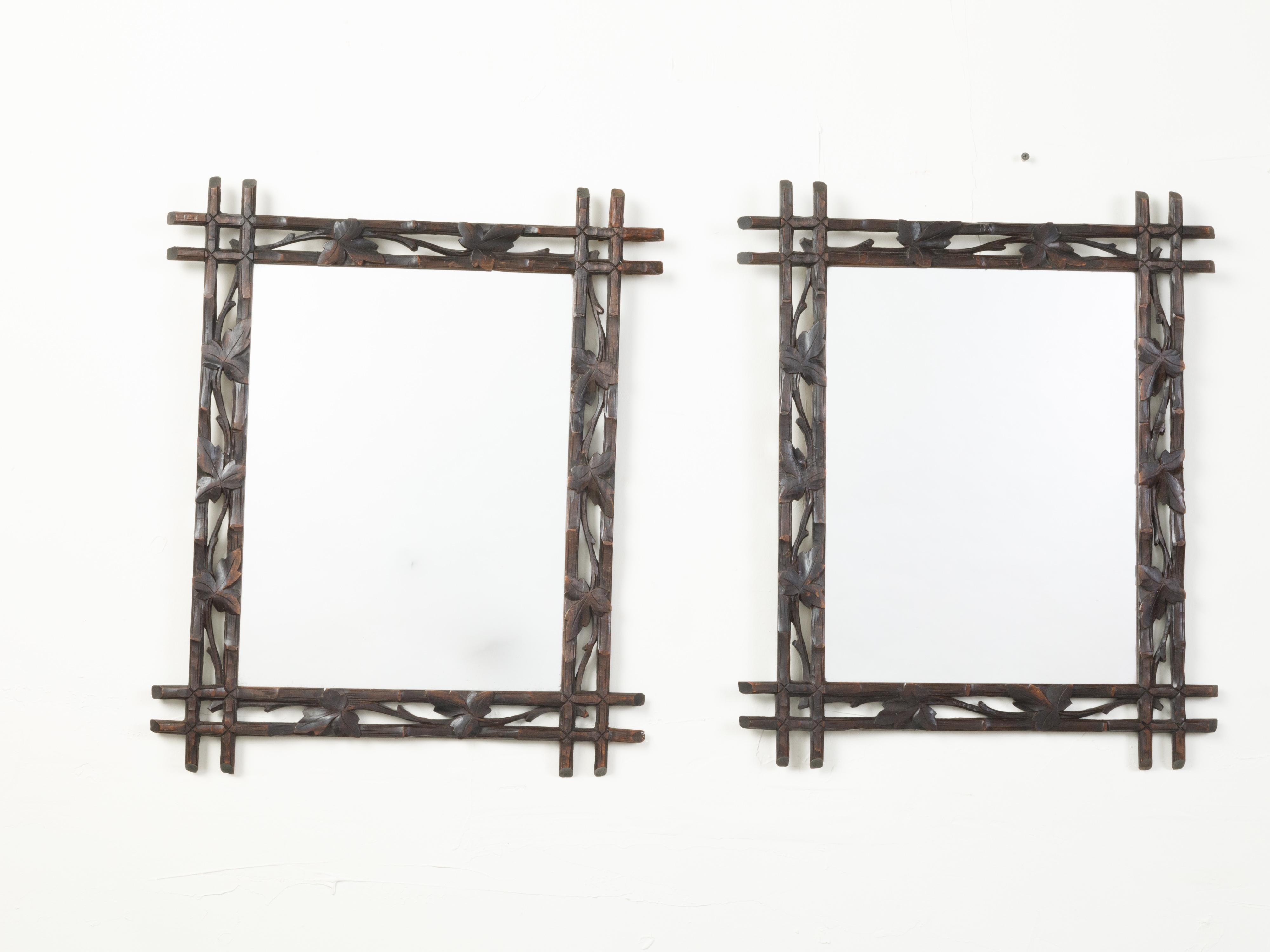 European Black Forest 1900s Mirror with Carved Vine Motifs and Intersecting Corners For Sale