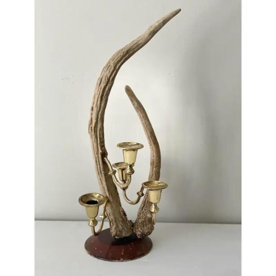 Fantastic tall natural-shed black forest antler and brass candelabra on wooden base.
In the manner of Ralph Lauren. Very well constructed. Great refined rustic look. Stunning centerpiece for a dining table or cocktail table. Refined, rustic handsome