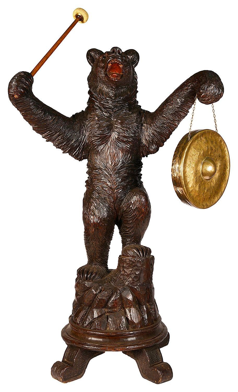 An enchanting Swiss Black Forest carved bear, holding a gong and hammer, mounted on a carved rocky outcrop.
 
 
Batch 73 YZZZ 62138