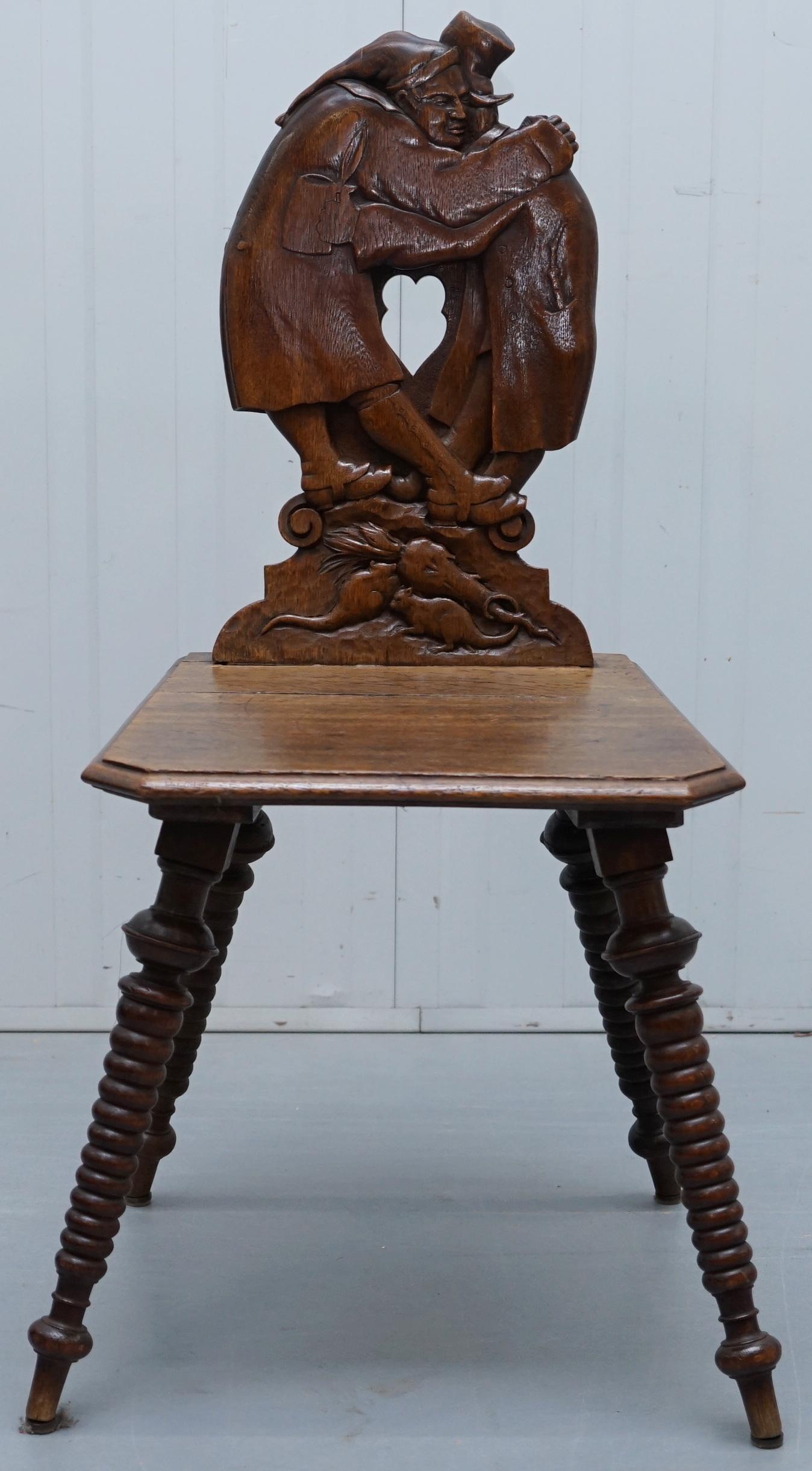 We are delighted to offer this very rare circa 1870 Black Forest carved oak hall chair with Bobbin turned legs and backrest depicting men hugging possibly Ebenezer Scrooge 

An attractive and well made piece, very decorative, ideally suited as an