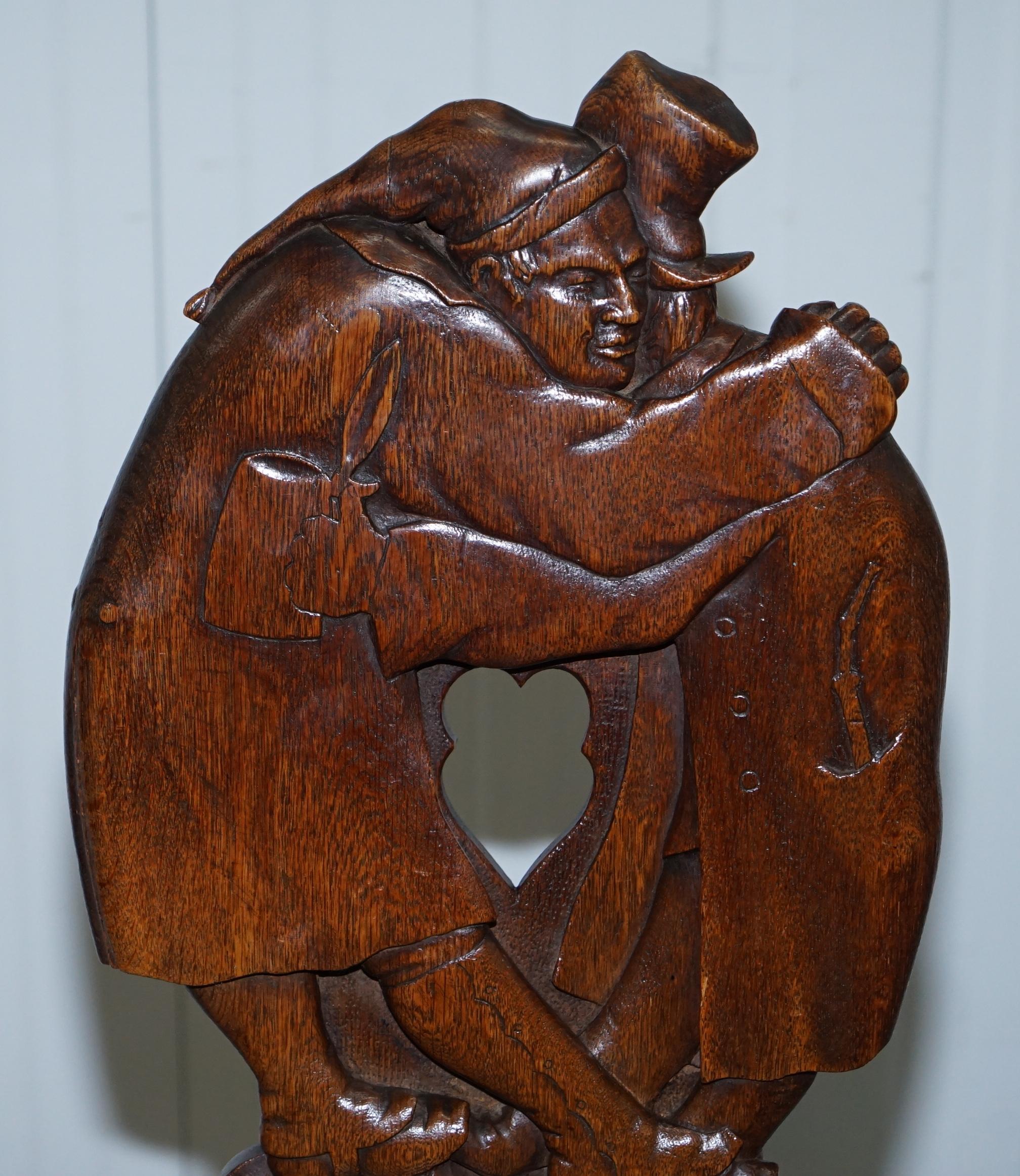 English Black Forest Carve Oak Bobbin Hall Chair Depicting Two Friends Hugging Scrooge For Sale