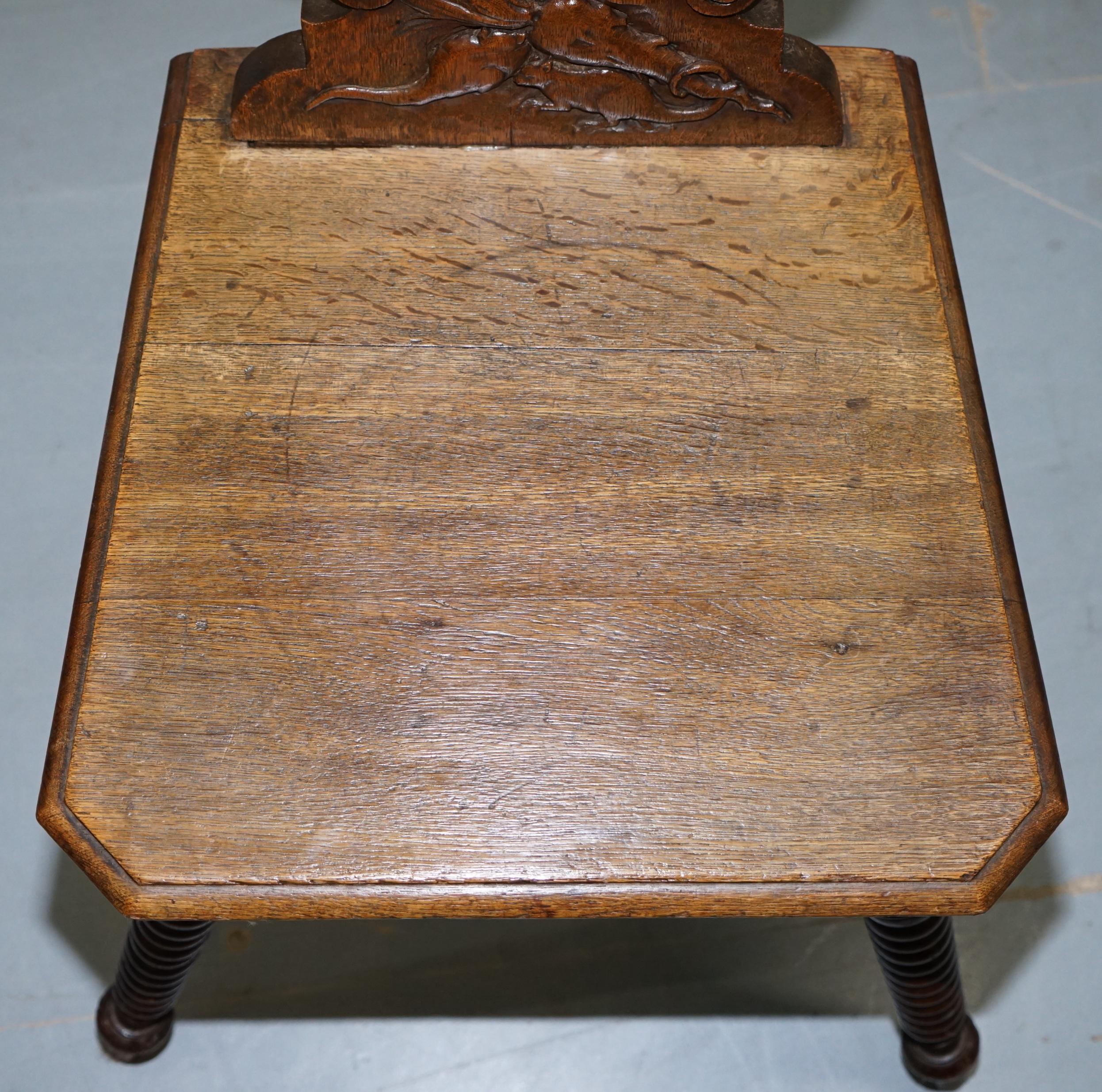Late 19th Century Black Forest Carve Oak Bobbin Hall Chair Depicting Two Friends Hugging Scrooge For Sale