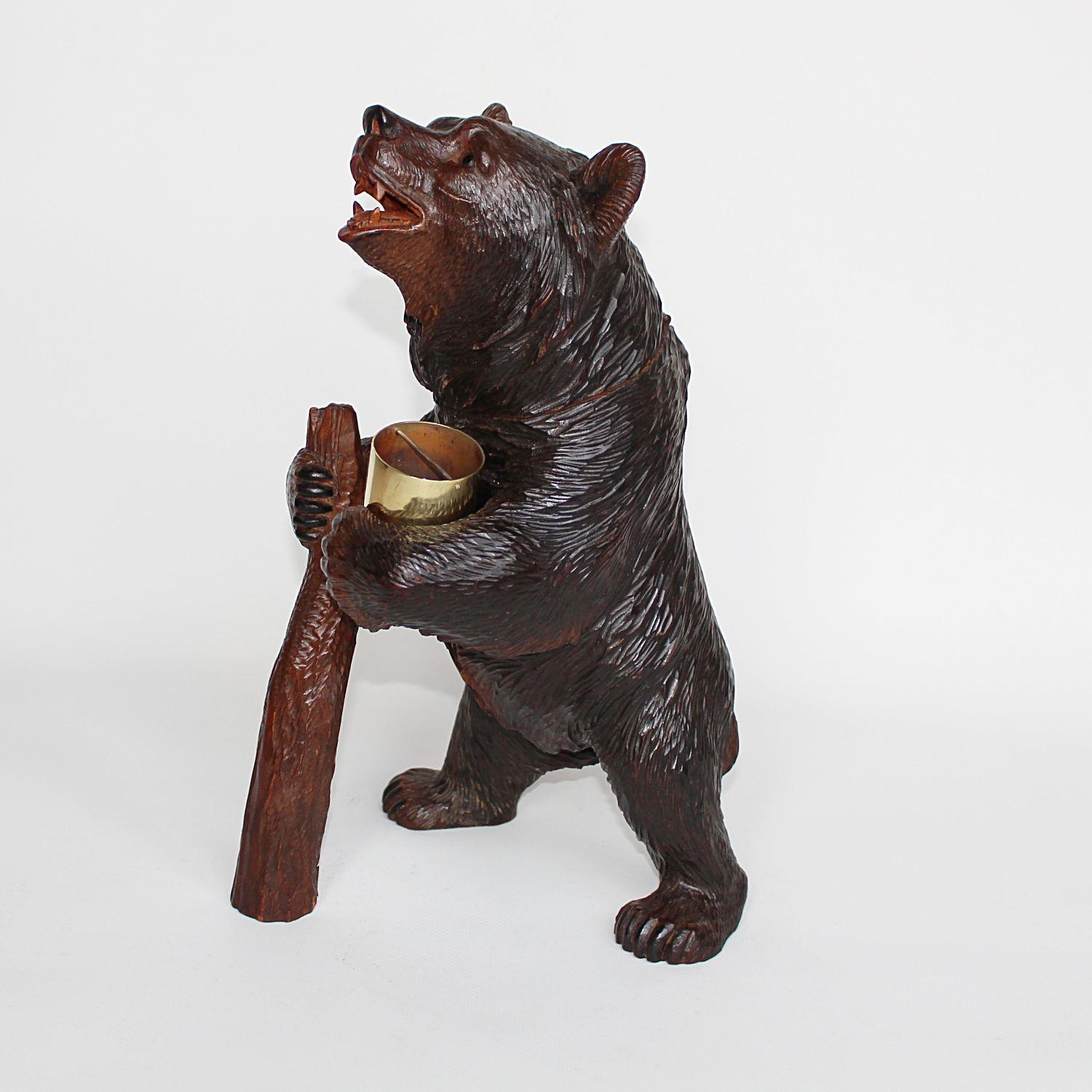 A Black Forest carved bear as a tobacco jar and match Stand. Finely carved detail. Original glass eyes. 

 