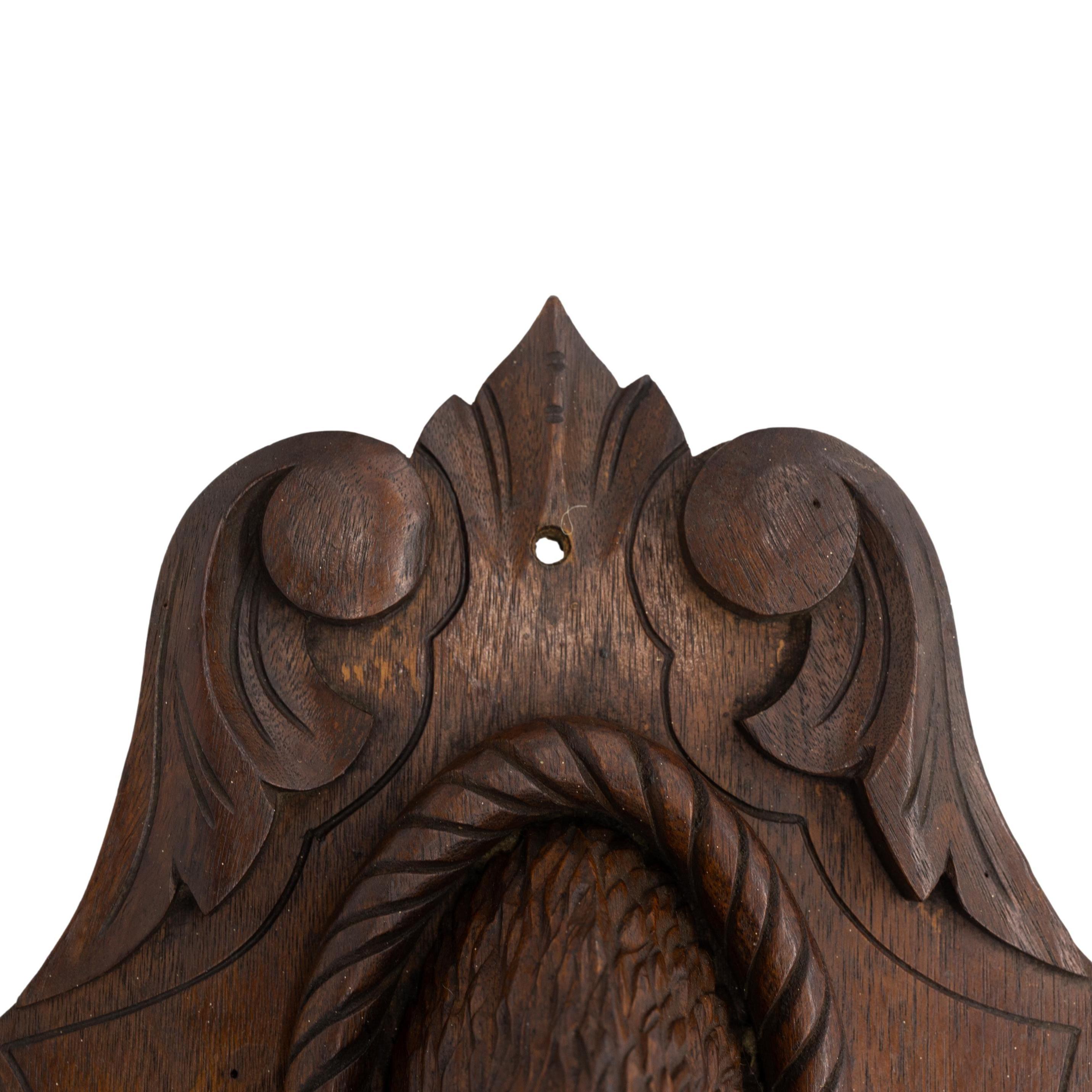 Black Forest Carved Linden Wood Deer Head, mounted on a carved and molded oak plaque, with a shaped and molded shelf, Brienz, Switzerland, ca. 1880.    
Jay Arenski quotes Swiss Poet Heinrich Federer, who said in his memoirs, 
