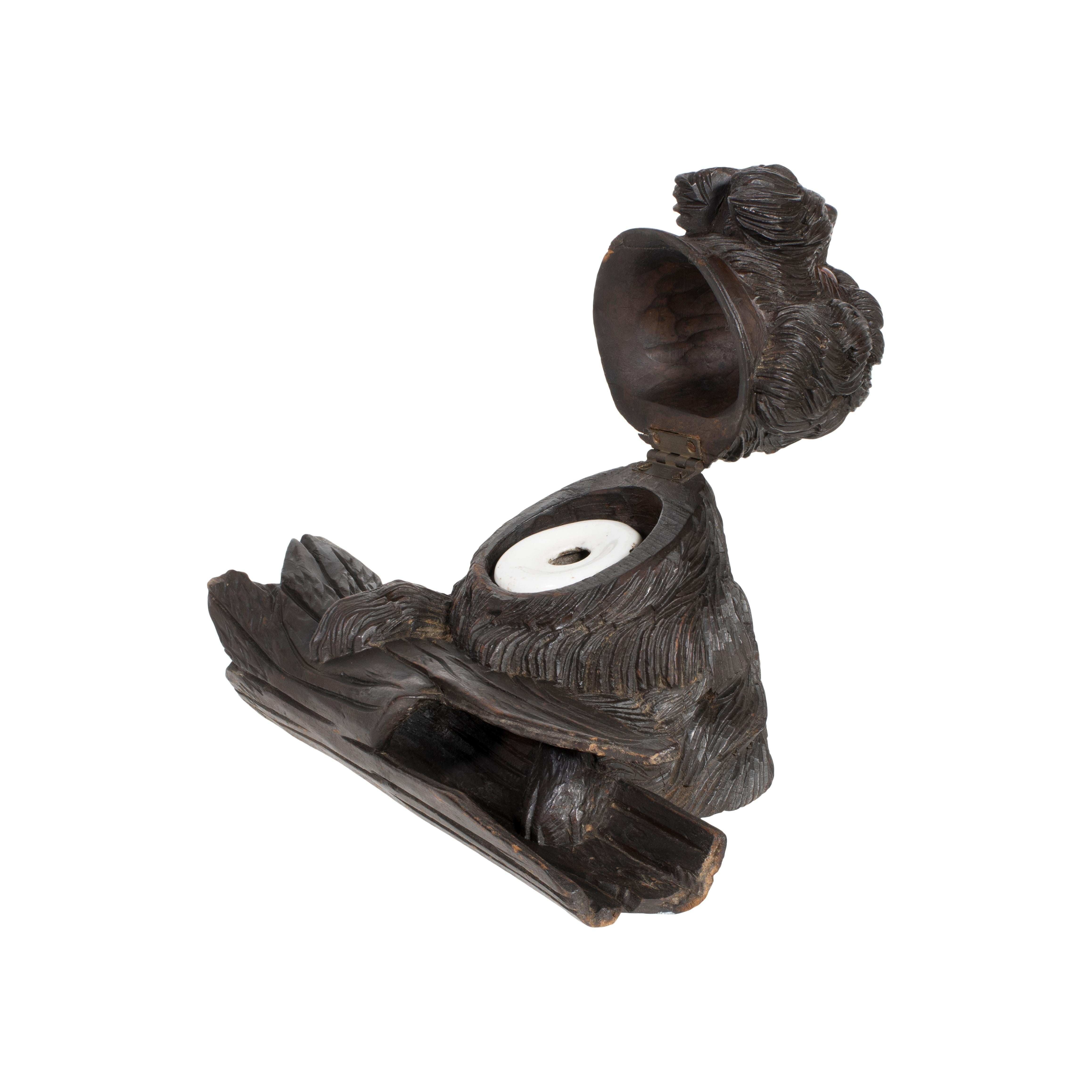 Swiss carved black Forest shaggy dog inkwell with pen holder. In the 1800’s the wood carving industry of Switzerland started in the town of Brienz. By the end of the 1800’s it had become the driving force for this industry. Swiss wood carvers became