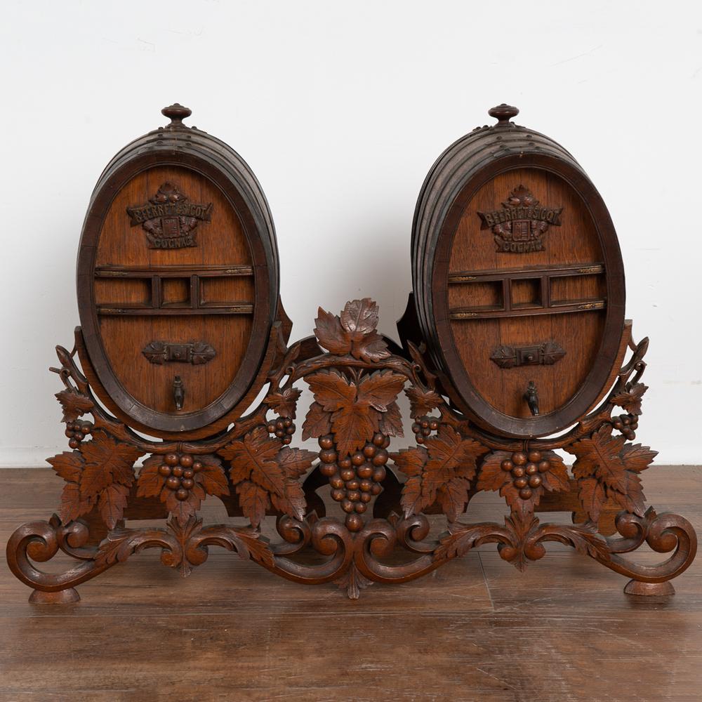 Traditional hand-carved oak leaves and grapes are the hallmark of this black forest table-top double wine barrel. More specifically, this was designed for cognac per the carved name 