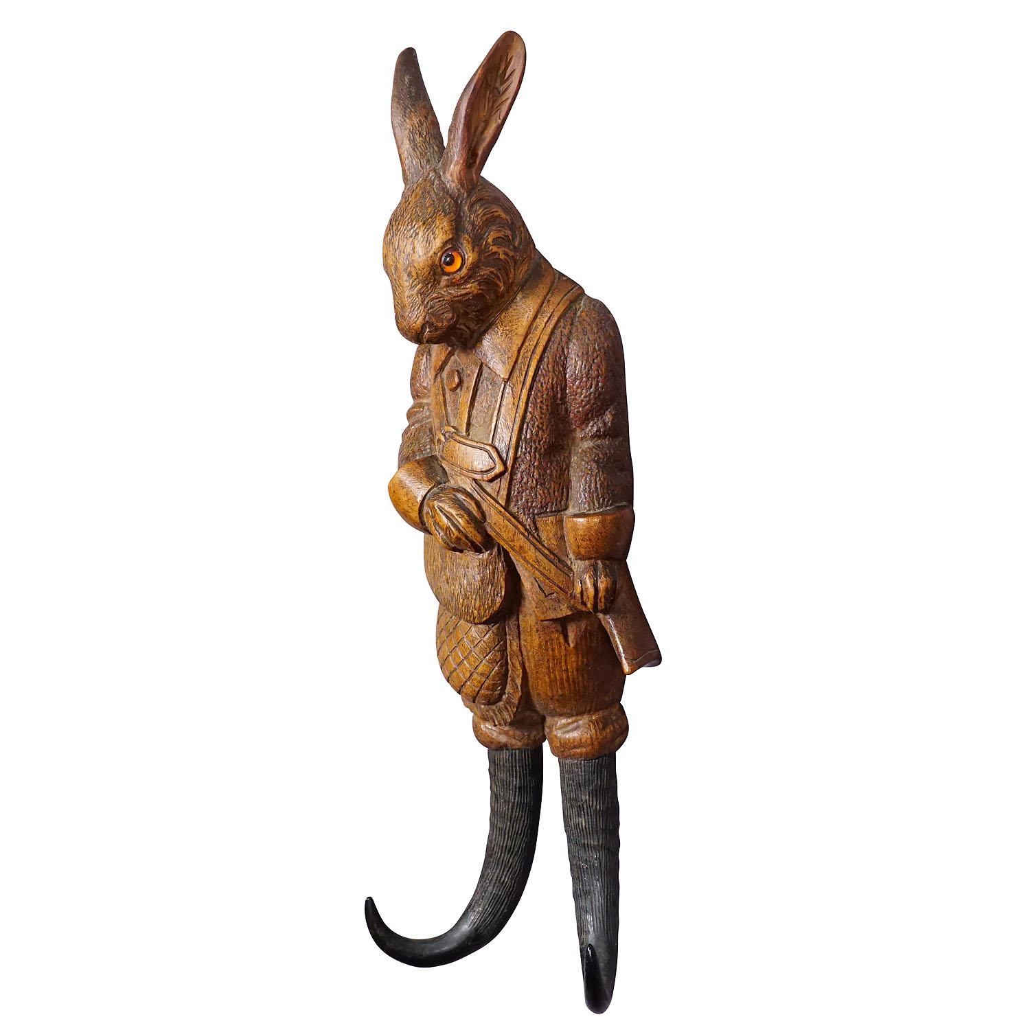 Black Forest Carved Hare Whip Holder or Wall Hook ca. 1900s

A handcarved cabin decor style coat hook or whip holder showing a hare with a gun. The hooks are made from genuine chamois horns. Handcarved in Brienz, Switzerland around 1900.

The