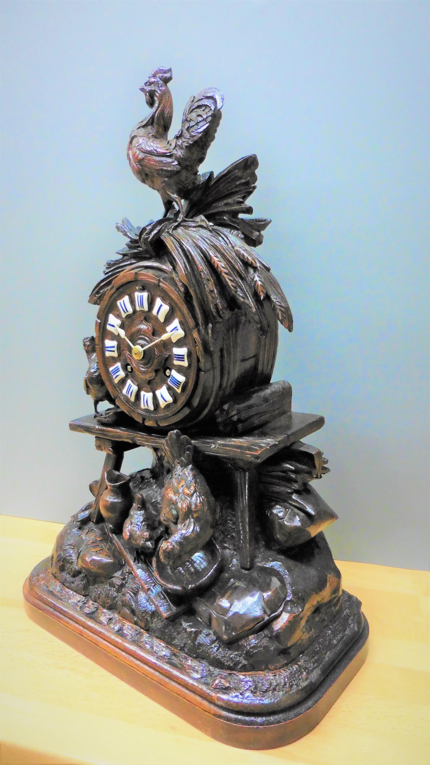 Black Forest carved mantel clock

Black Forest mantel clock beautifully hand carved with fine attention to detail depicting a farmyard scene with a hen and chick feeding and a cockerel resting on a wheat sheaf surmounting the clock which rests on