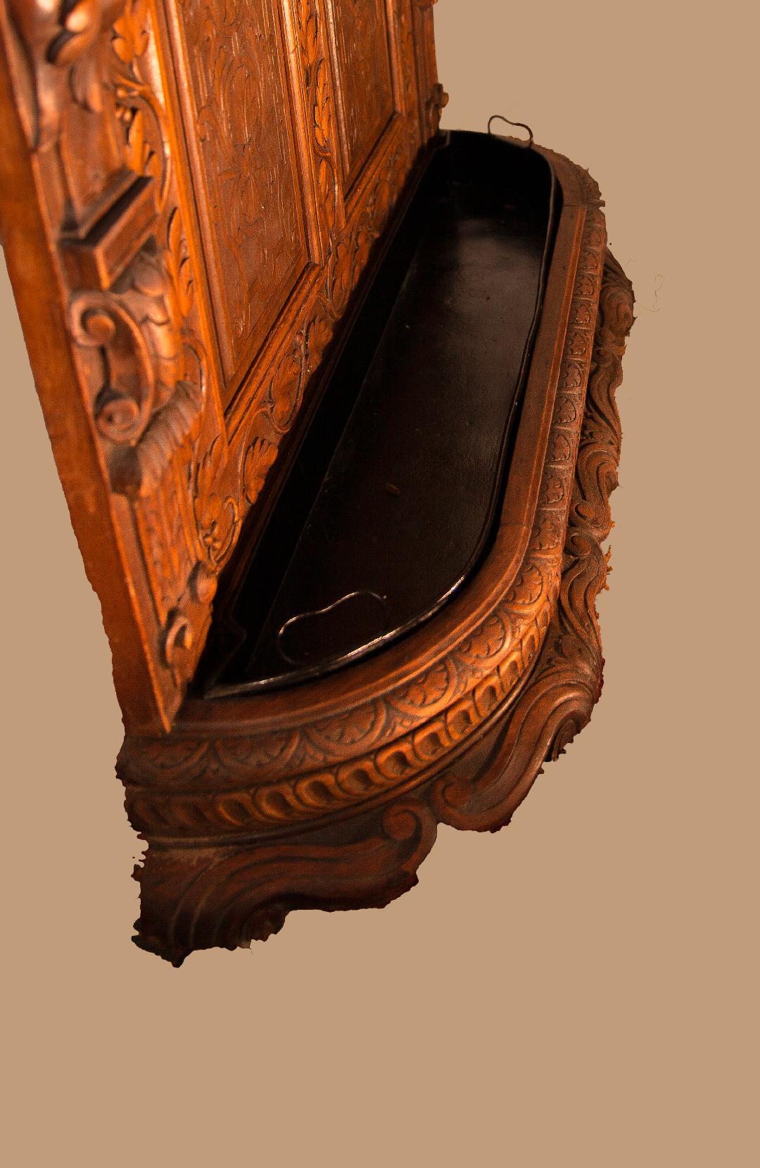 An outstanding hand carved Black Forest Hall stand, circa 1890 in solid oak. This is of the highest quality and craftsmanship with cast brass fittings of mythical dolphins and will grace any grand entryway. 
These Black Forest pieces are very hard