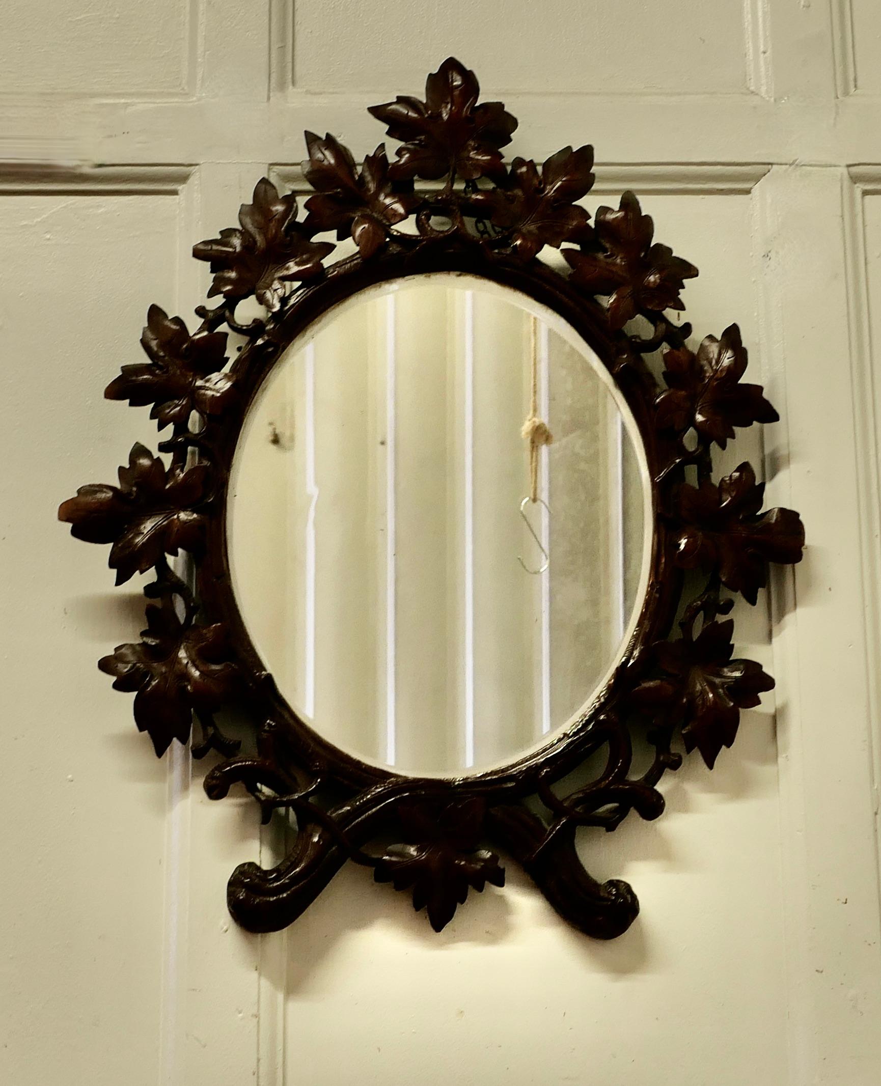Black Forest carved oval mirror

A lovely piece, the 4” wide frame has an intricately carved border. It is carved with many large entwining leaves 
The mirror is in good condition, the frame is also good with the expected age related