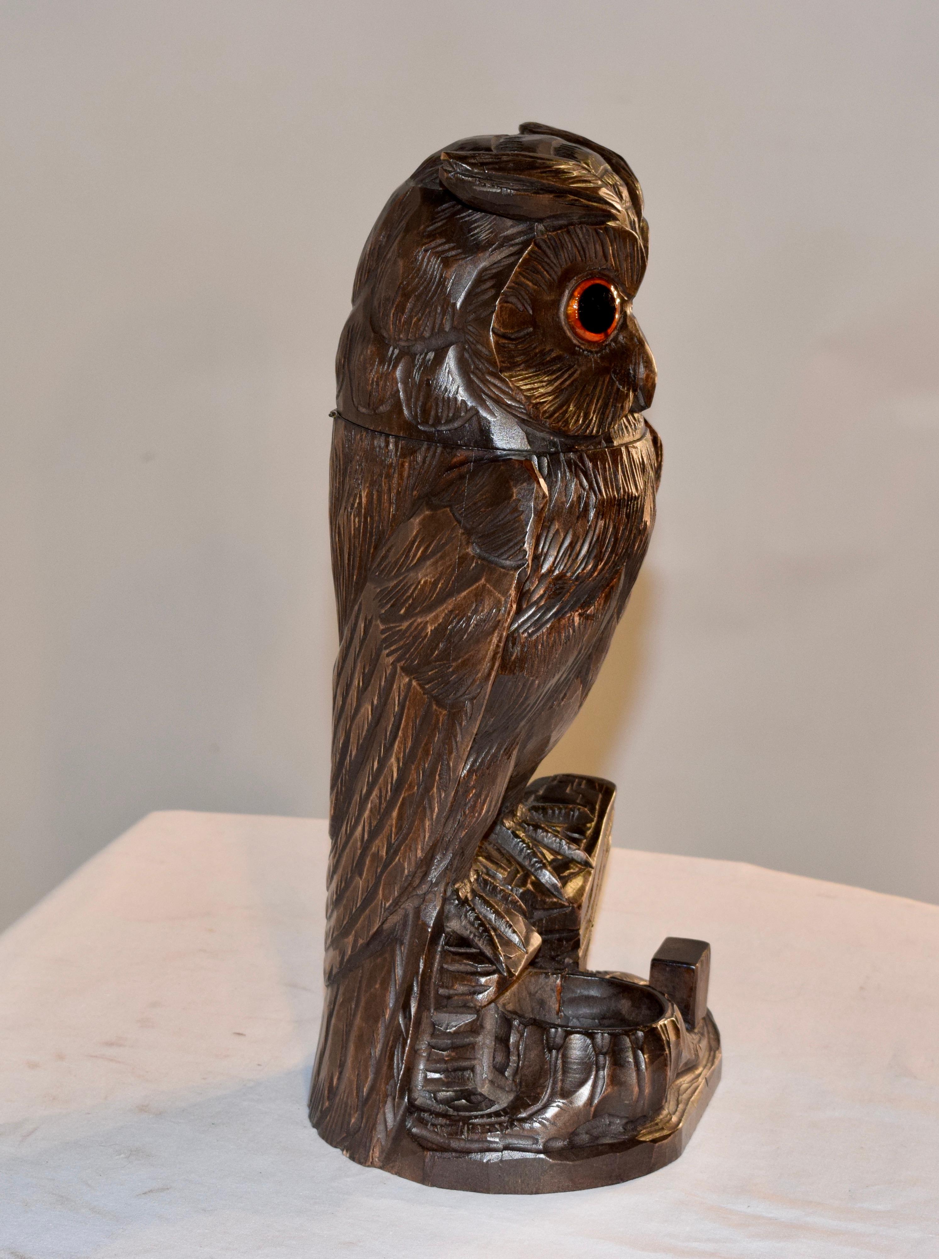 Hand carved humidor in the shape of an owl from Switzerland, circa 1900. The owl's head tilts back to reveal a compartment for tobacco storage.