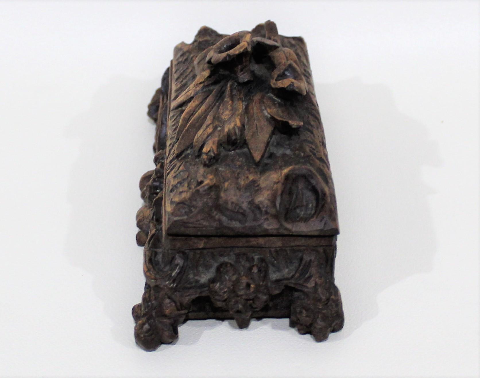 19th century Black Forest wood box with floral and foliate designs throughout.