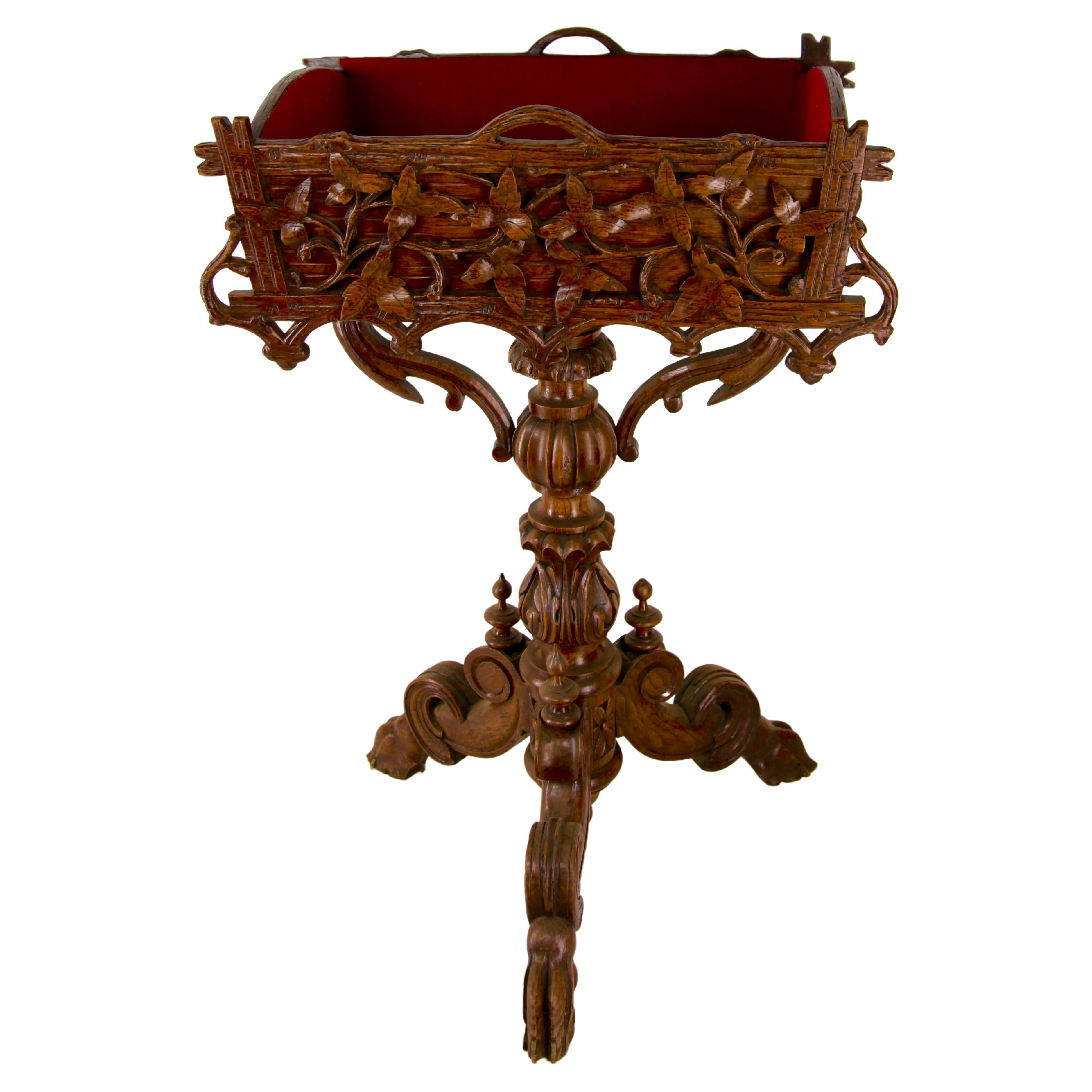 The Wooden Planter features a pierced carving of a floral basket flanked by scrolled Grapevines. And sides of the box are carved to look like rough wooden boards. Raised on a Turned and Hand Carved pedestal, the pedestal are joined whit two carved