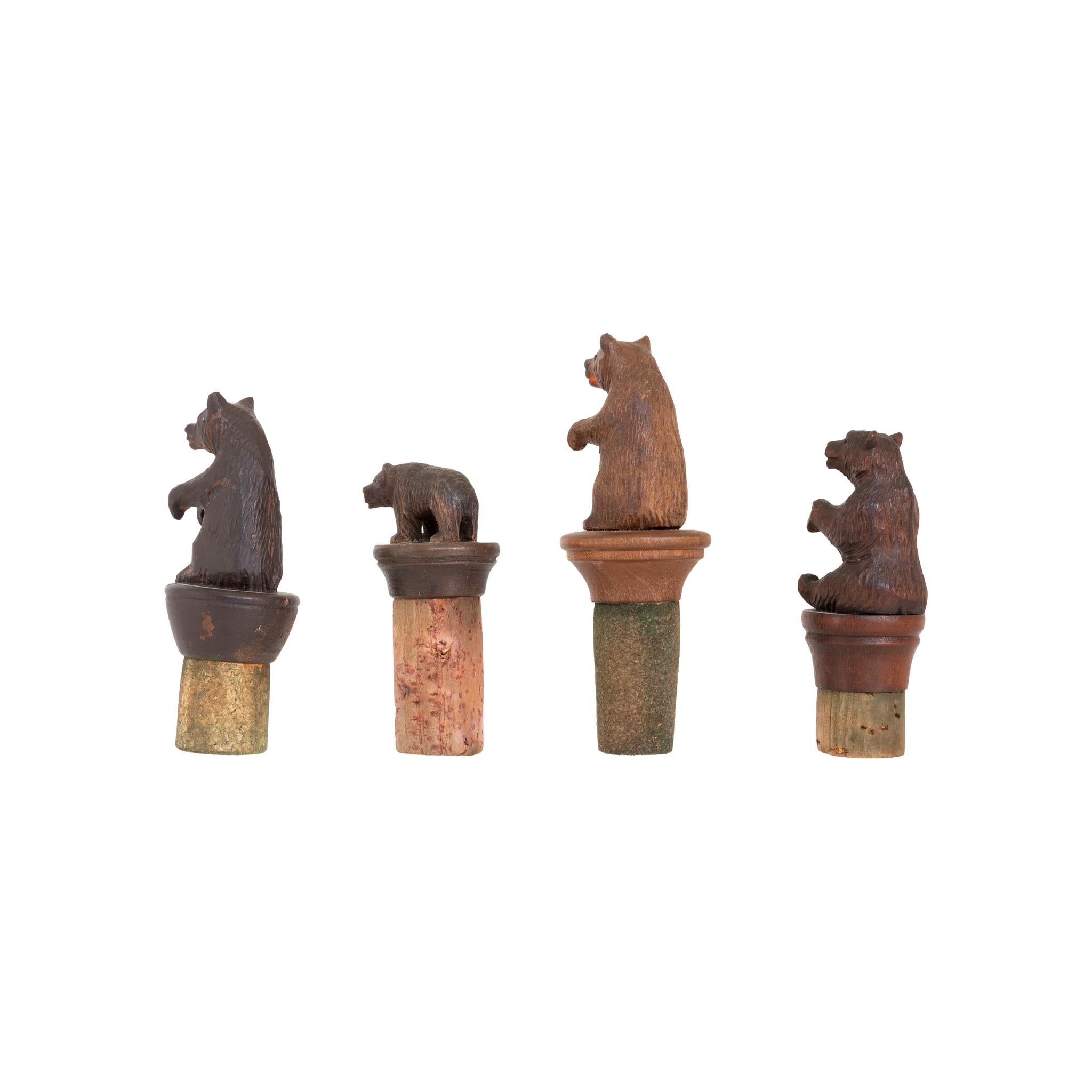 Collection of four miniature carved Swiss bears mounted on corks for wine bottle stoppers. All different.

PERIOD: Circa 1900
ORIGIN: Switzerland
SIZE: Longest 2 1/2