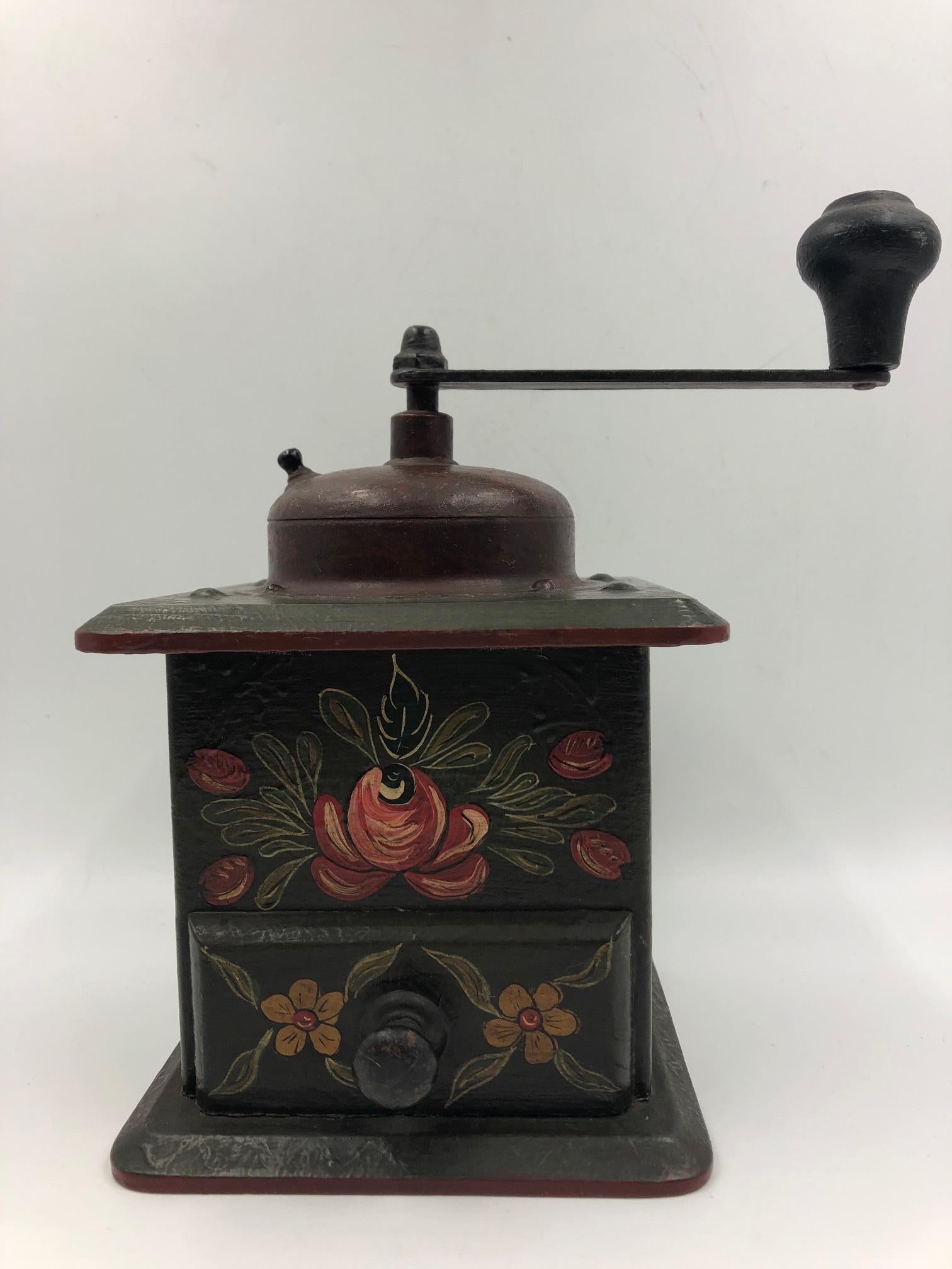Early 20th century coffee grinder with shaped top and treen handle. Hand painted.